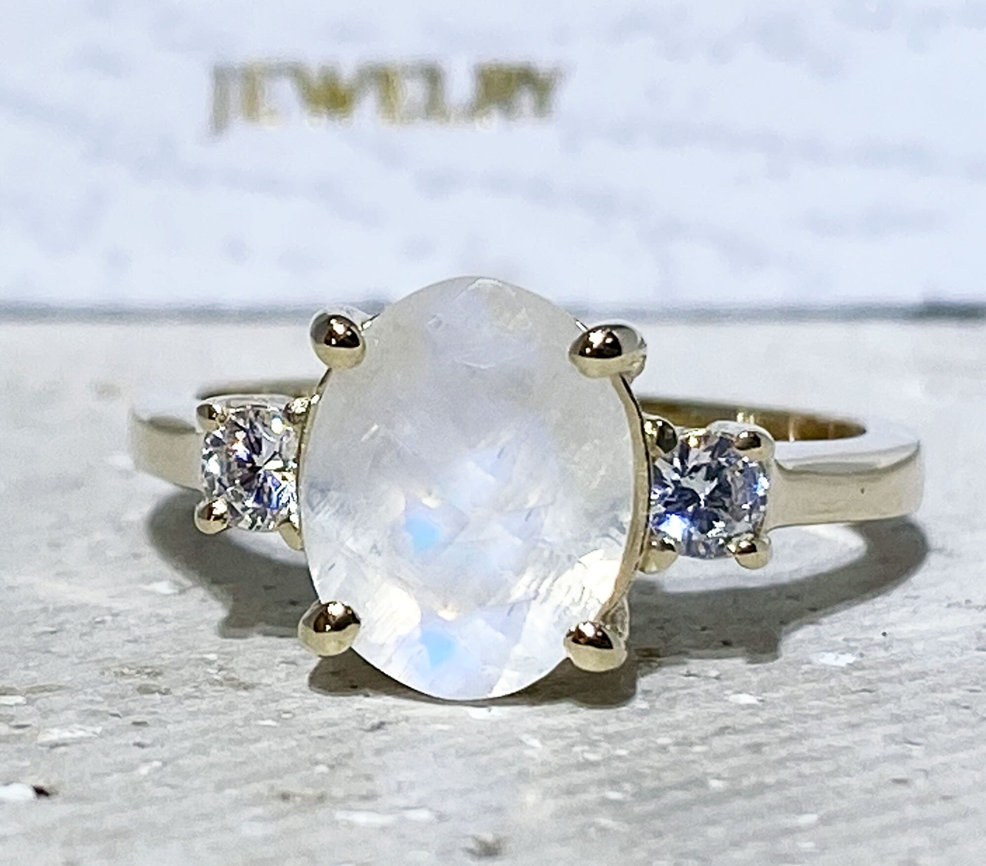 Exquisite, lovely women&#39;s oval cut genuine moonstone ring set with 2 round cut clear quartz.