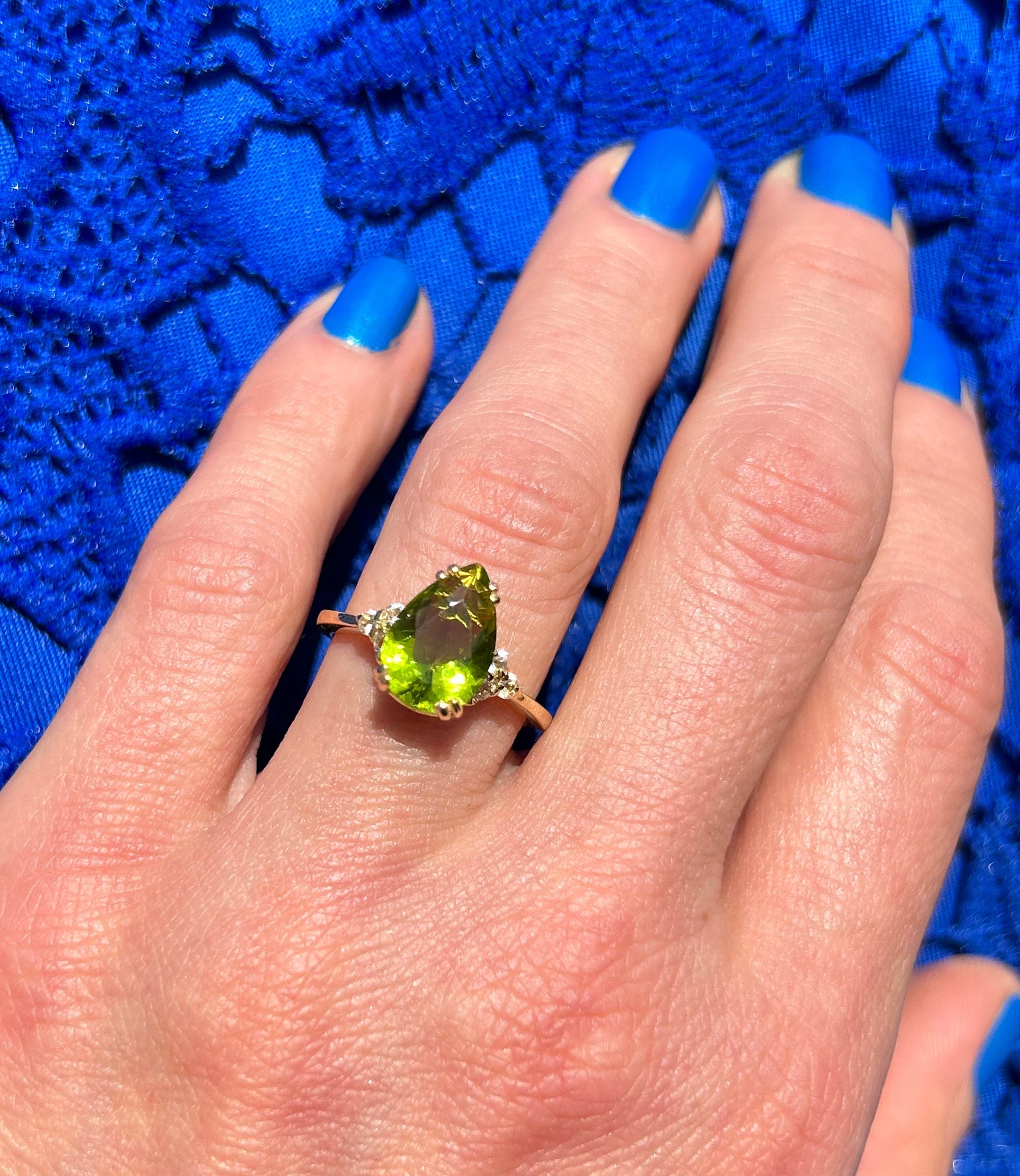 An absolute stunner, classic peridot engagement ring with a pear cut gemstone of your choice as it’s centre stone and with round cut clear quartz on the band to further accentuate it.