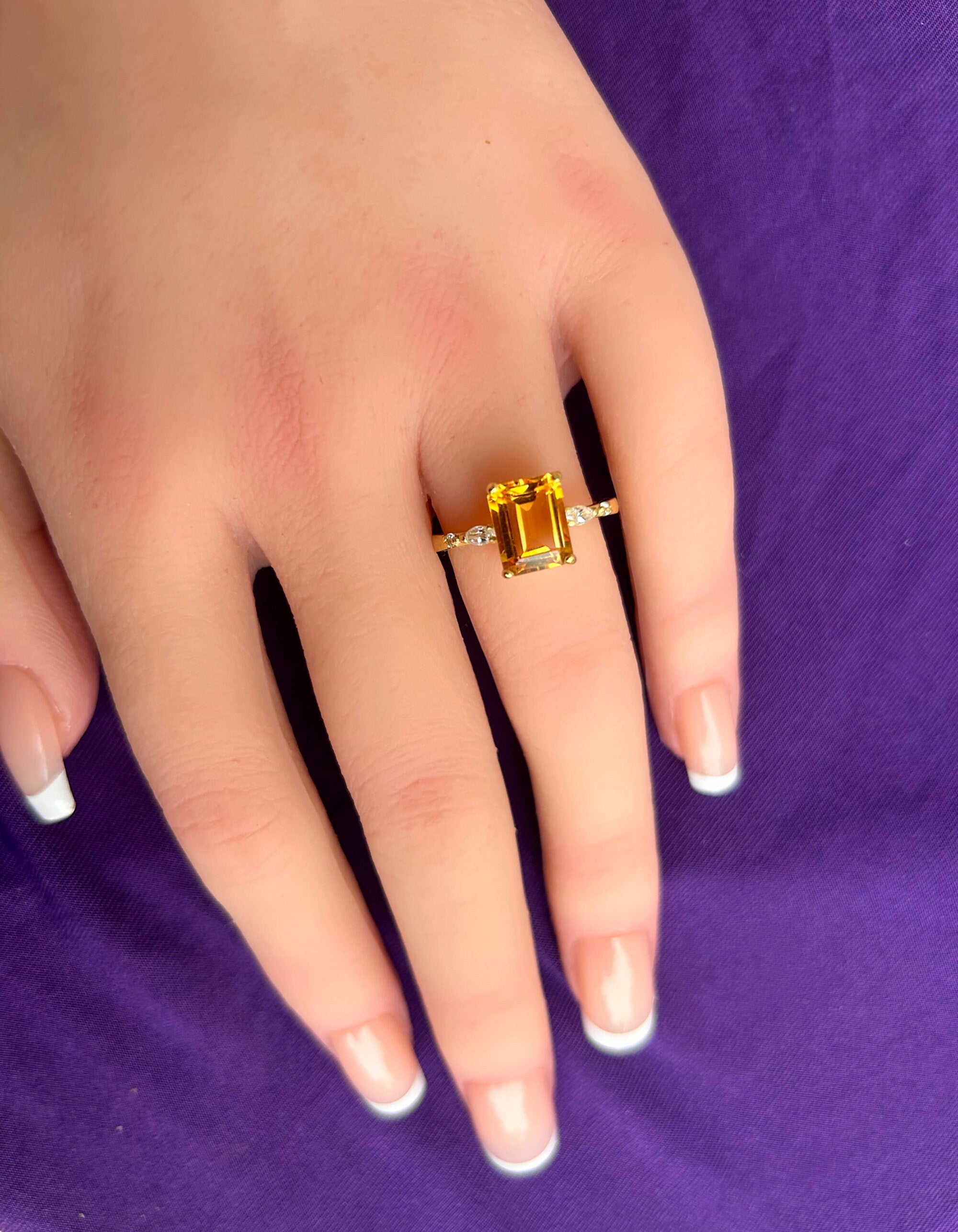 An absolute stunner, classic natural citrine engagement ring with an emerald cut gemstone of your choice as it’s centre stone and with clear quartz on the band to further accentuate it.