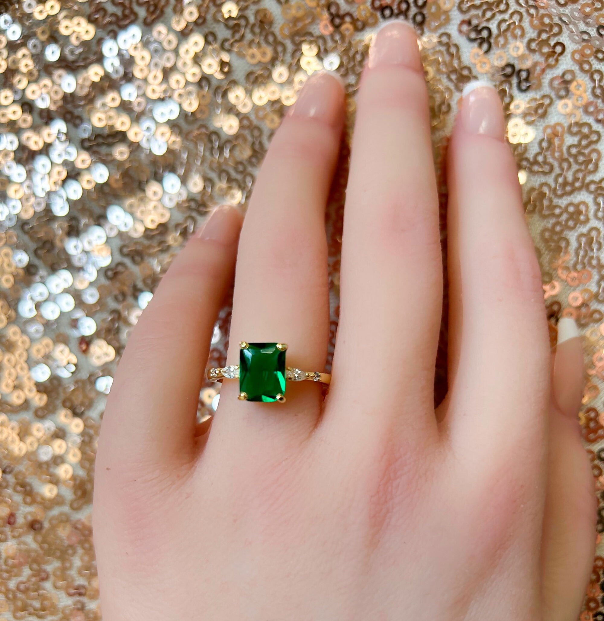 An absolute stunner, classic emerald engagement ring with an emerald cut gemstone of your choice as it’s centre stone and with clear quartz on the band to further accentuate it.