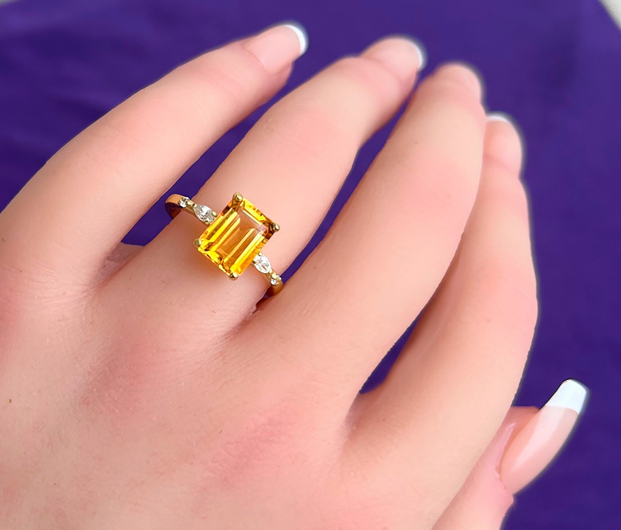 An absolute stunner, classic natural citrine engagement ring with an emerald cut gemstone of your choice as it’s centre stone and with clear quartz on the band to further accentuate it.