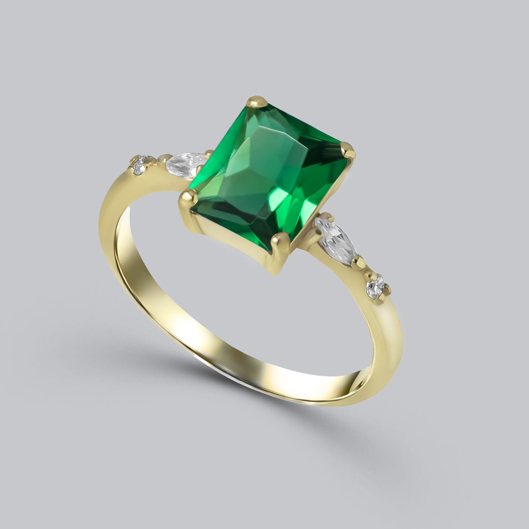 An absolute stunner, classic emerald engagement ring with an emerald cut gemstone of your choice as it’s centre stone and with clear quartz on the band to further accentuate it.