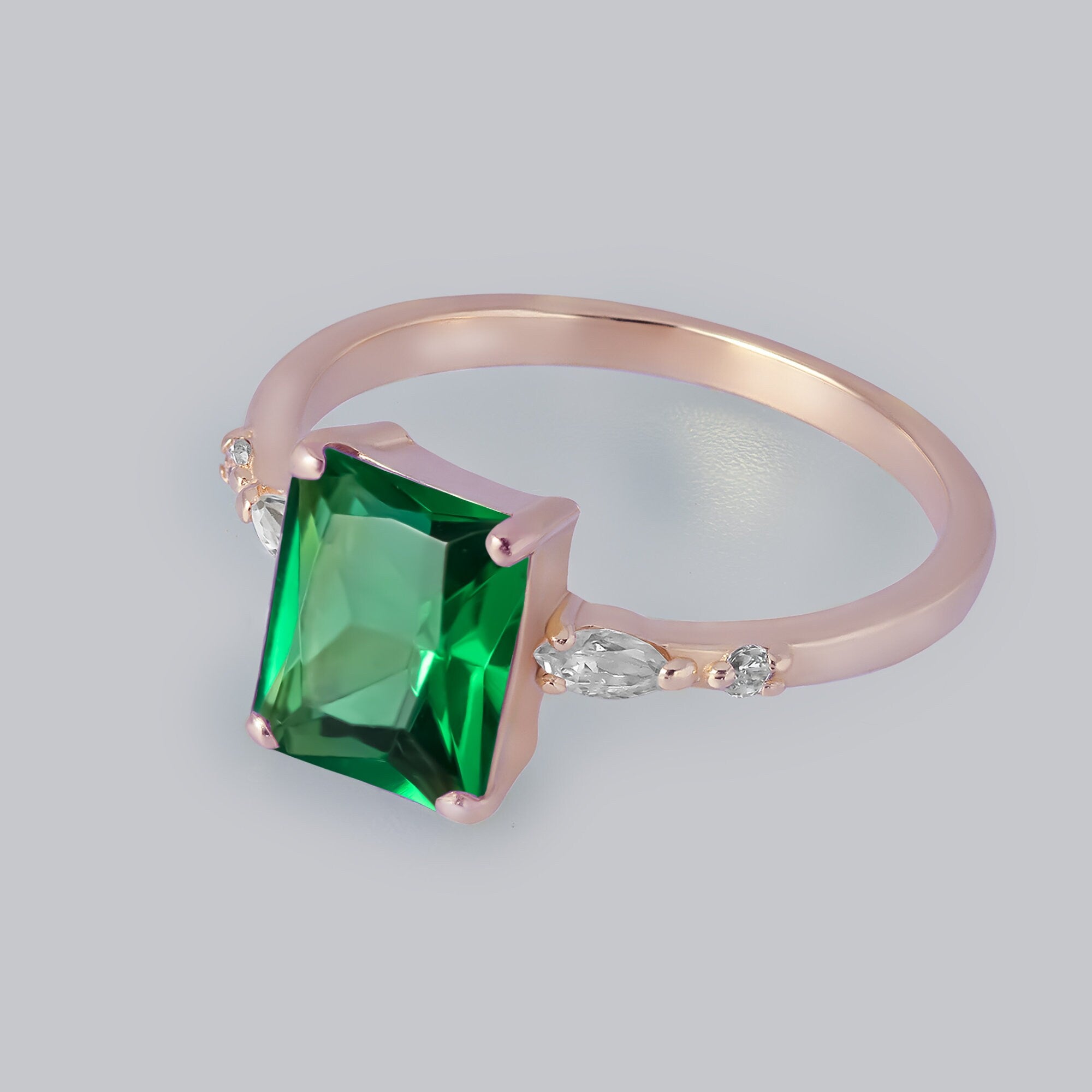 An absolute stunner, classic emerald engagement ring with an emerald cut gemstone of your choice as it’s centre stone and with clear quartz on the band to further accentuate it.