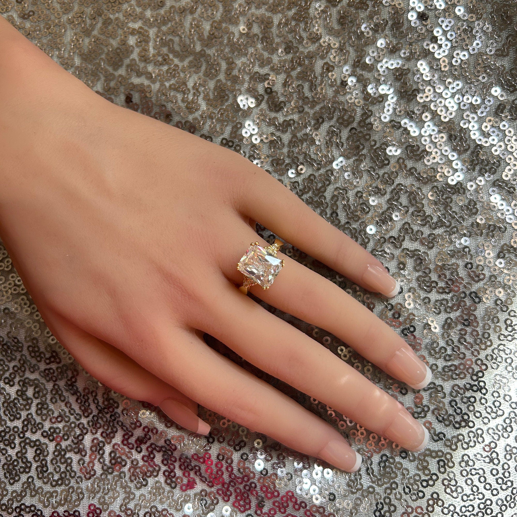 An absolute stunner, classic clear quartz engagement ring with an emerald cut gemstone of your choice as it’s centre stone and with round cut clear quartz on the band to further accentuate it.