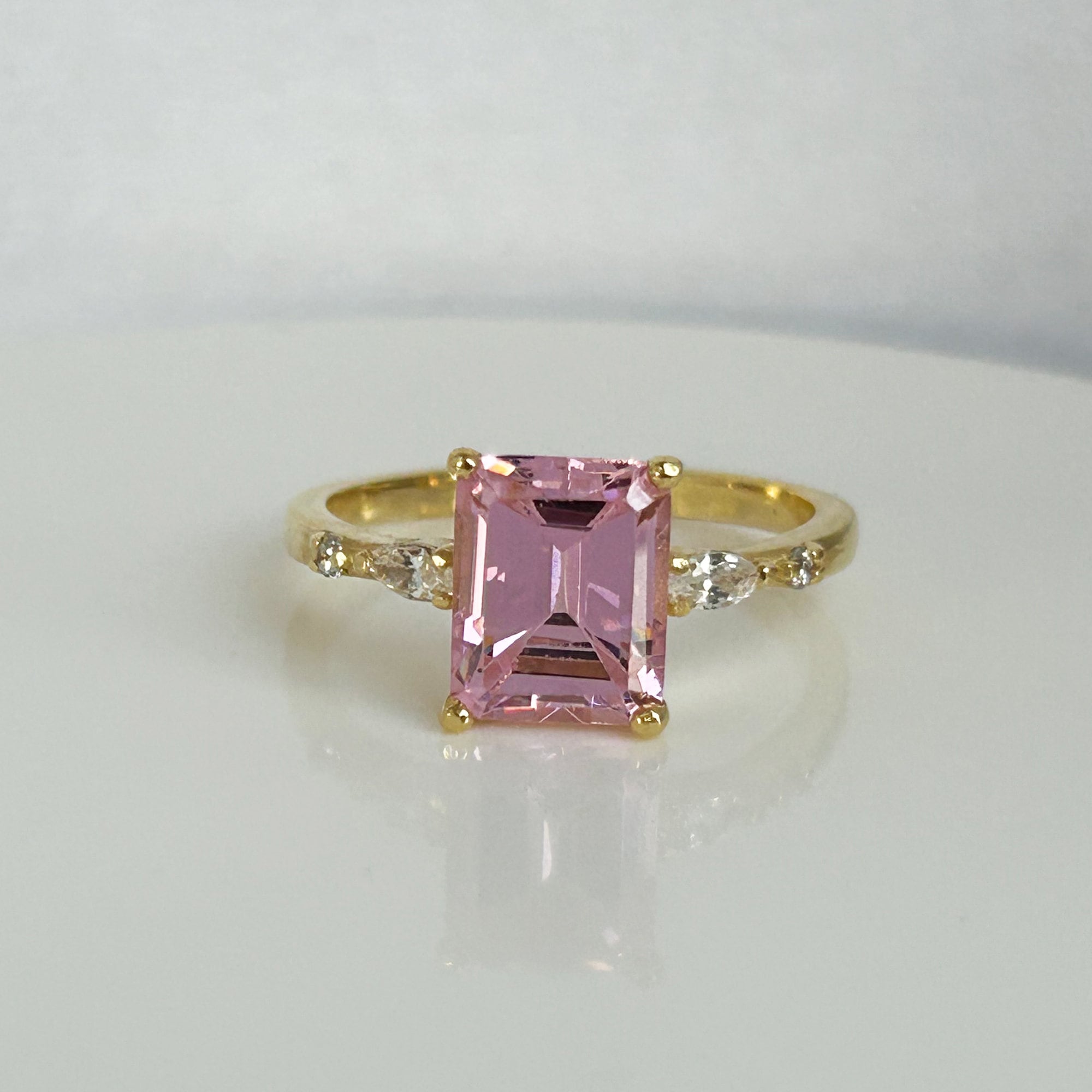 An absolute stunner, classic rose quartz engagement ring with an emerald cut gemstone of your choice as it’s centre stone and with round cut clear quartz on the band to further accentuate it.