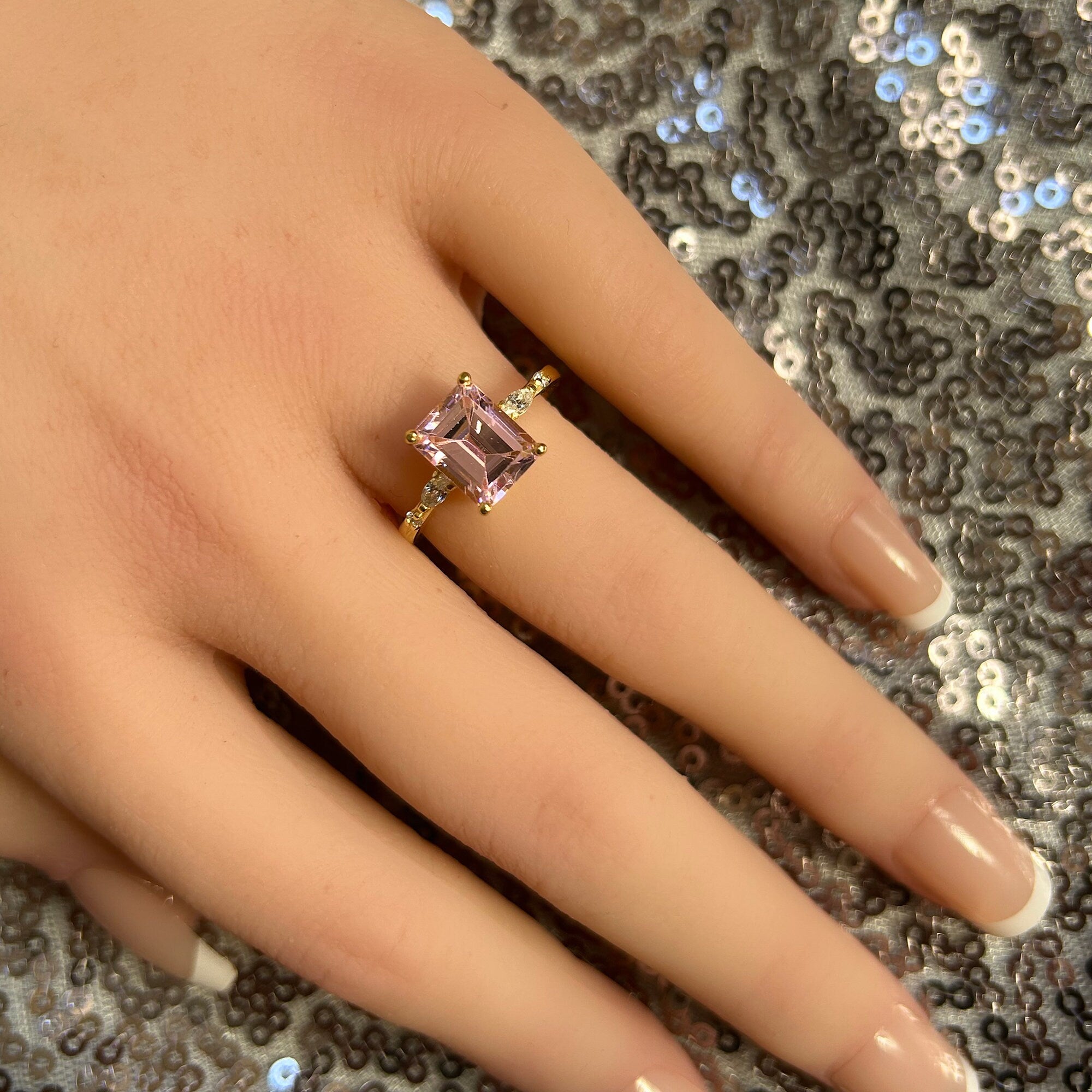 An absolute stunner, classic rose quartz engagement ring with an emerald cut gemstone of your choice as it’s centre stone and with round cut clear quartz on the band to further accentuate it.