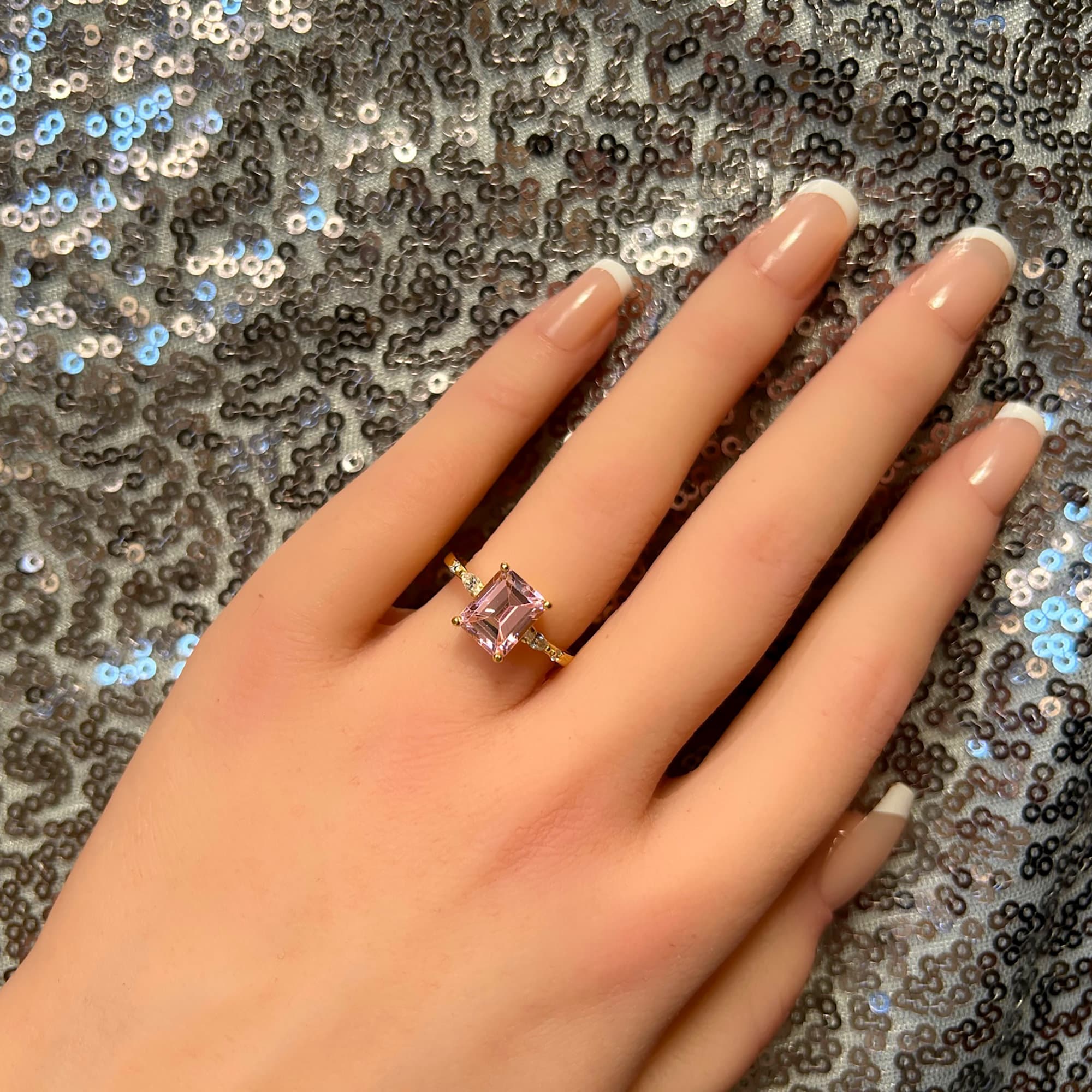 An absolute stunner, classic rose quartz engagement ring with an emerald cut gemstone of your choice as it’s centre stone and with round cut clear quartz on the band to further accentuate it.