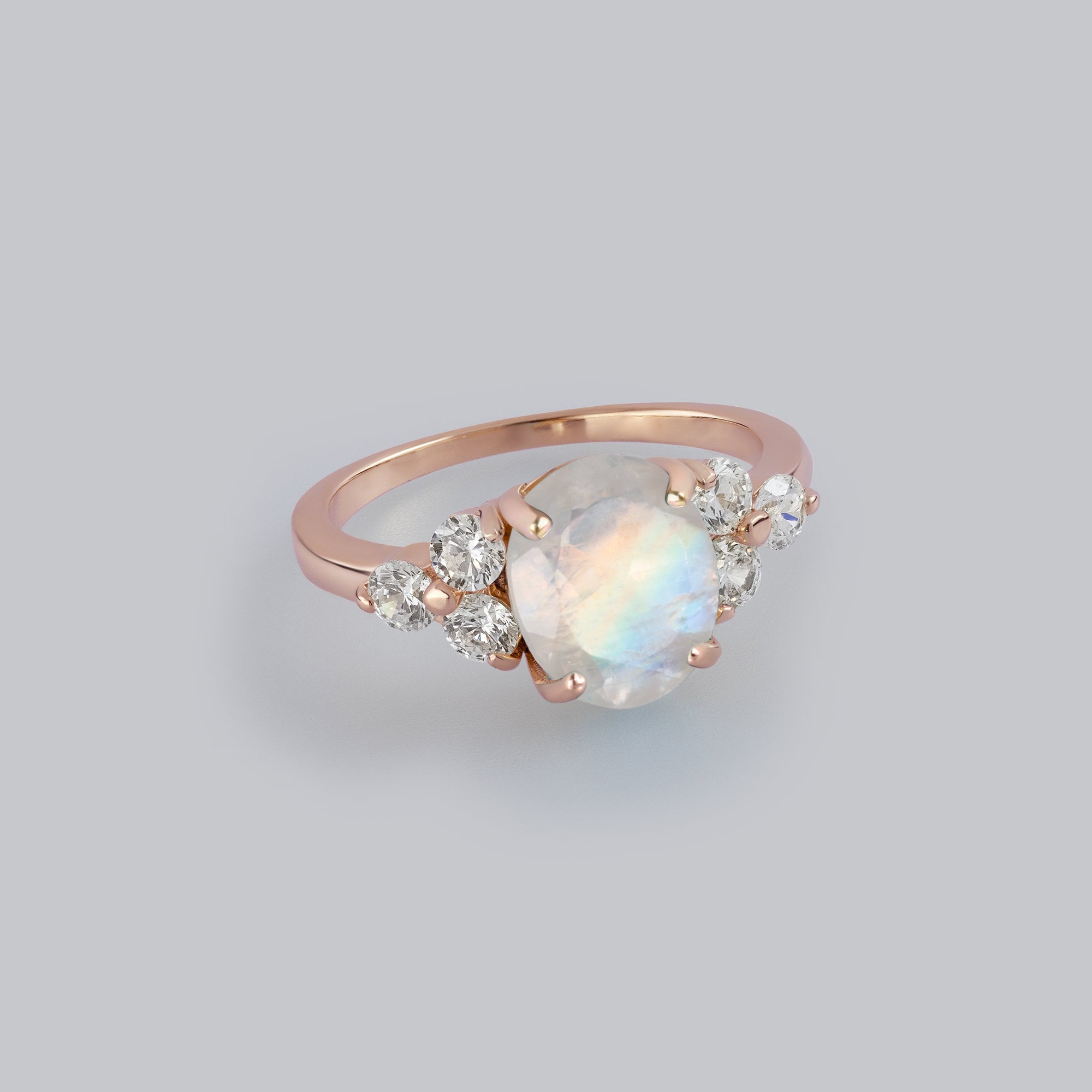 An absolute stunner, classic natural moonstone engagement ring with an oval cut gemstone of your choice as it’s centre stone and with round cut clear quartz on the band to further accentuate it.