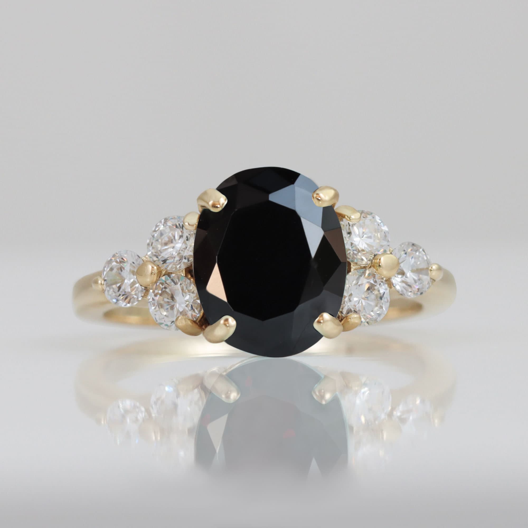 An absolute stunner, classic natural onyx engagement ring with an oval cut gemstone of your choice as it’s centre stone and with round cut clear quartz on the band to further accentuate it.