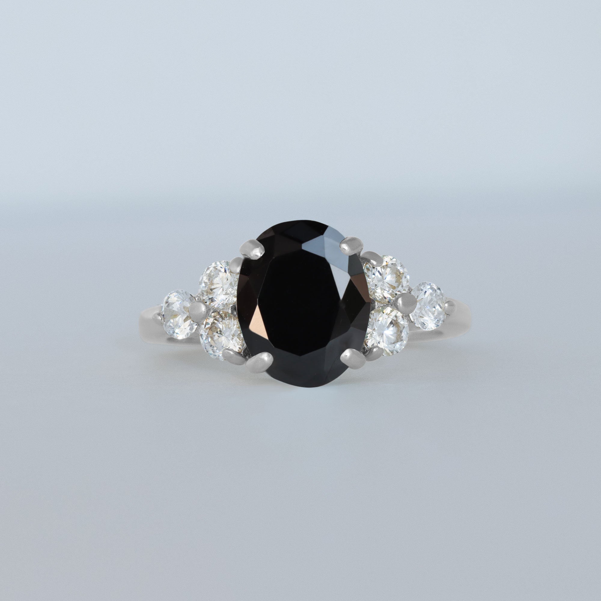 An absolute stunner, classic natural onyx engagement ring with an oval cut gemstone of your choice as it’s centre stone and with round cut clear quartz on the band to further accentuate it.