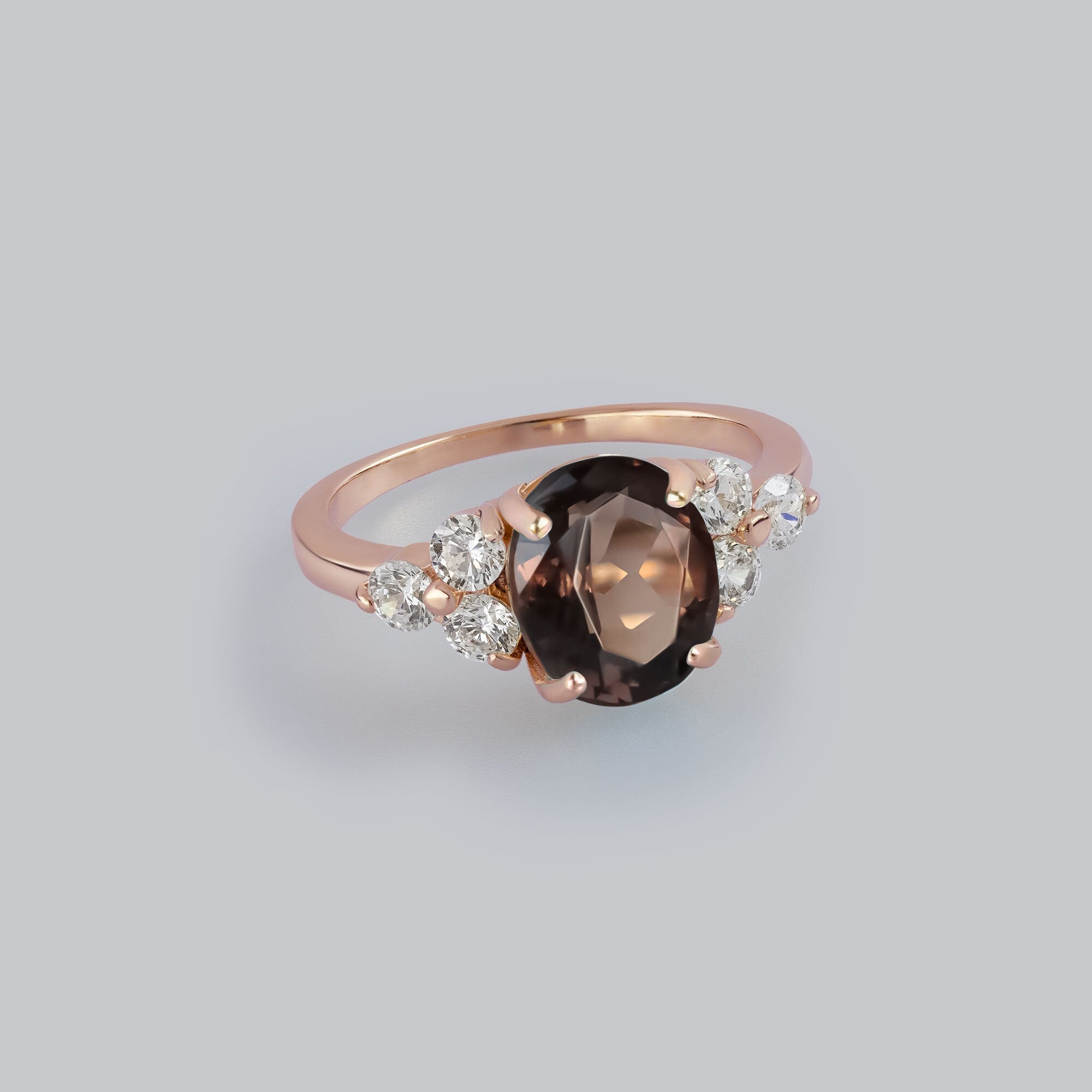 An absolute stunner, classic natural smoky quartz engagement ring with an oval cut gemstone of your choice as it’s centre stone and with round cut clear quartz on the band to further accentuate it.