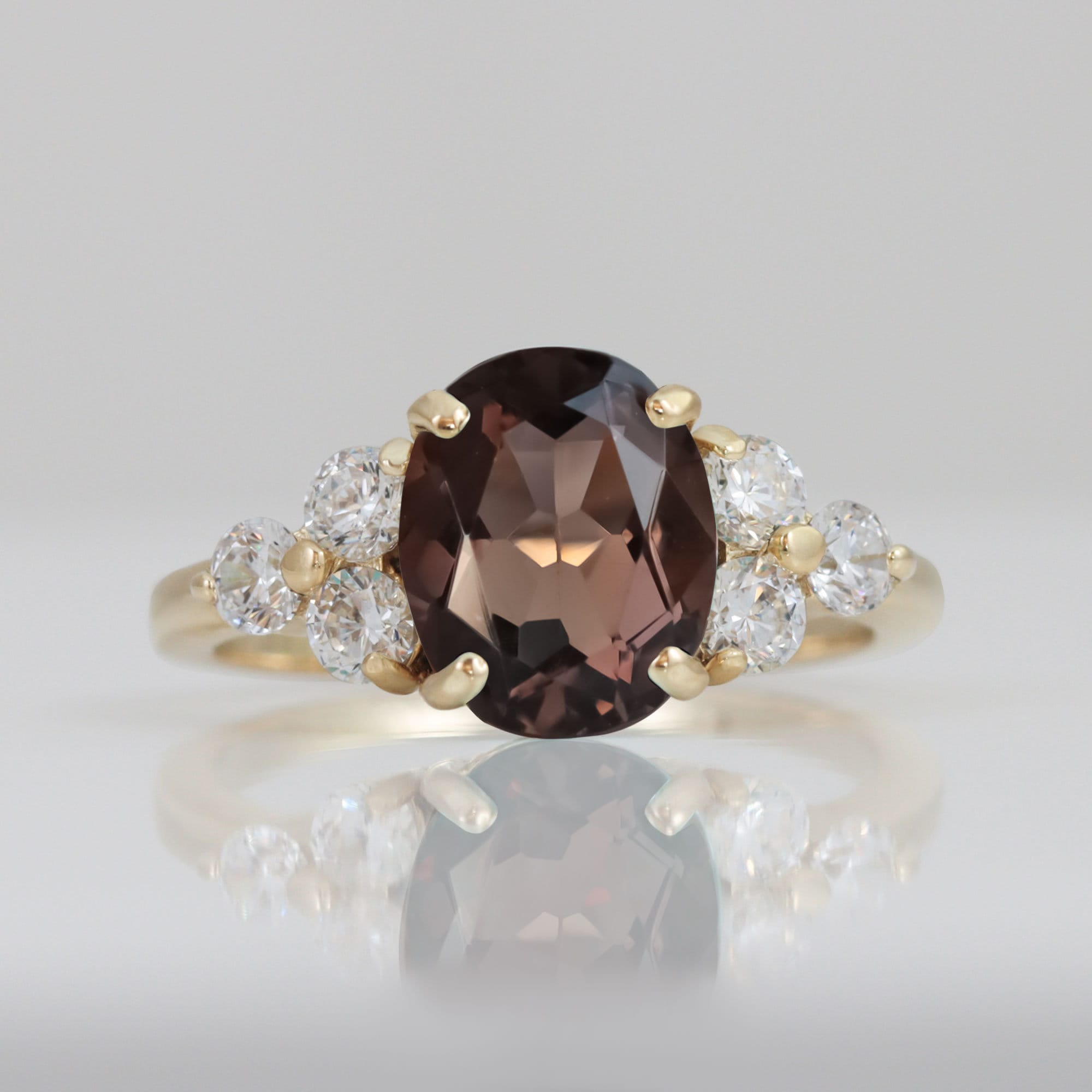 An absolute stunner, classic natural smoky quartz engagement ring with an oval cut gemstone of your choice as it’s centre stone and with round cut clear quartz on the band to further accentuate it.