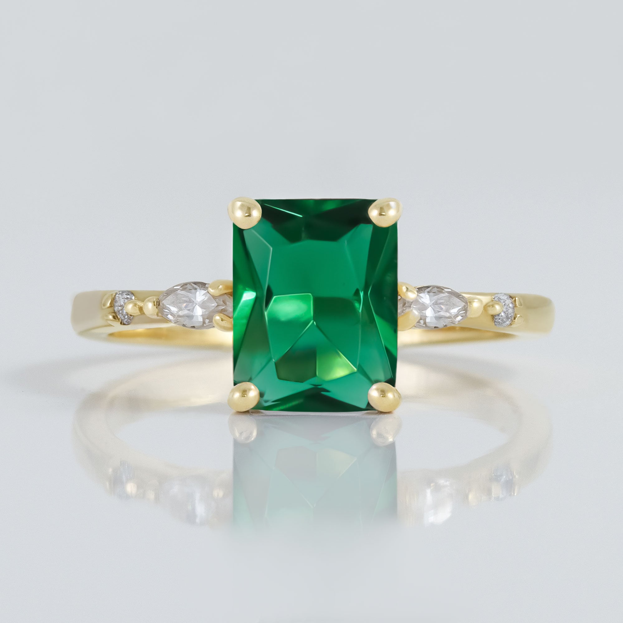 An absolute stunner, classic emerald engagement ring with an emerald cut gemstone of your choice as it’s centre stone and with clear quartz on the band to further accentuate it.