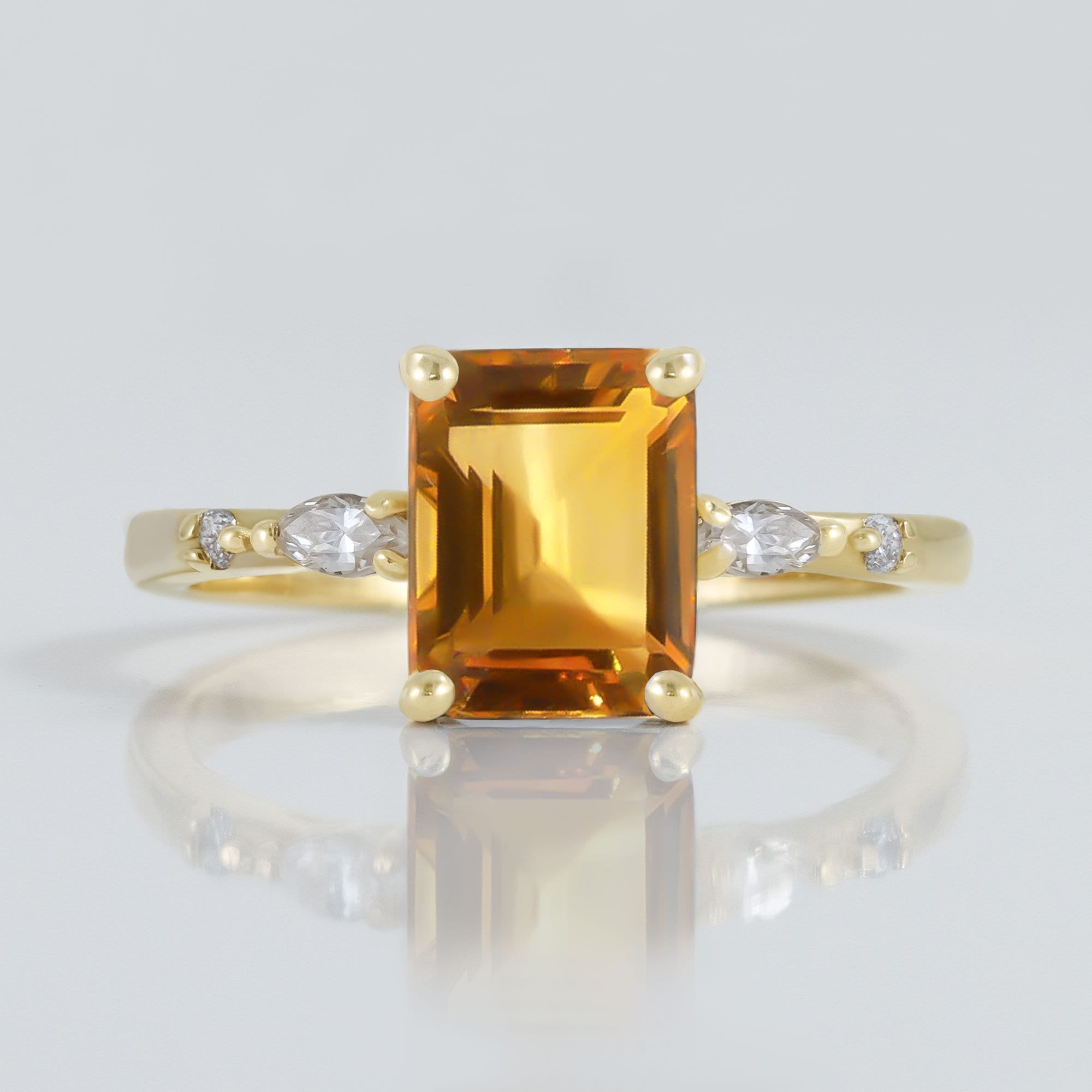 An absolute stunner, classic natural citrine engagement ring with an emerald cut gemstone of your choice as it’s centre stone and with clear quartz on the band to further accentuate it.