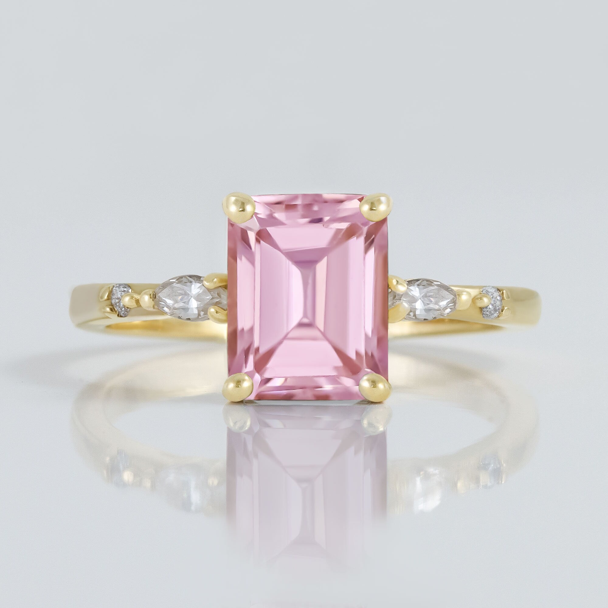 An absolute stunner, classic rose quartz engagement ring with an emerald cut gemstone of your choice as it’s centre stone and with round cut clear quartz on the band to further accentuate it