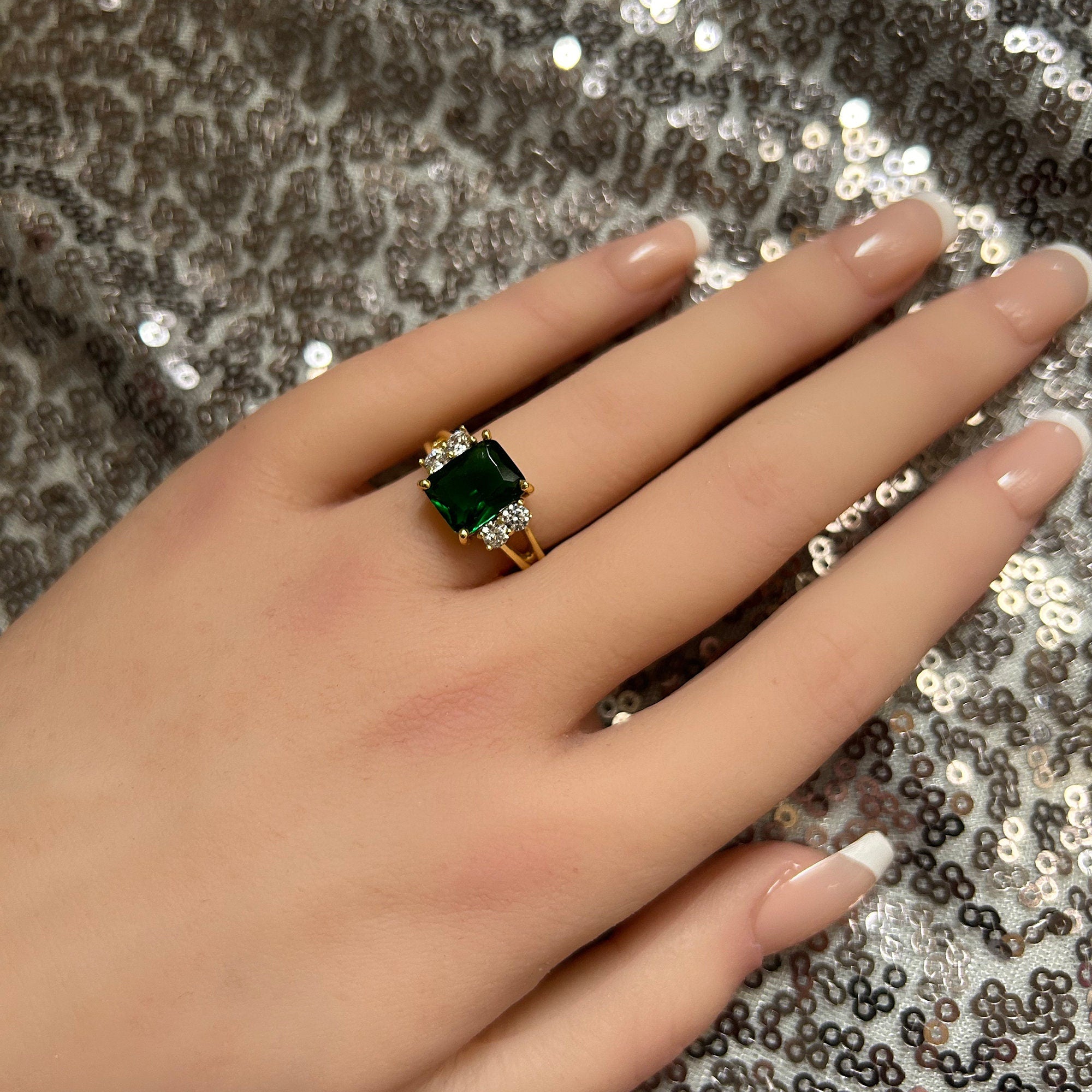 An absolute stunner, classic emerald engagement ring with an emerald cut gemstone of your choice as it’s centre stone and with round cut clear quartz on the band to further accentuate it.