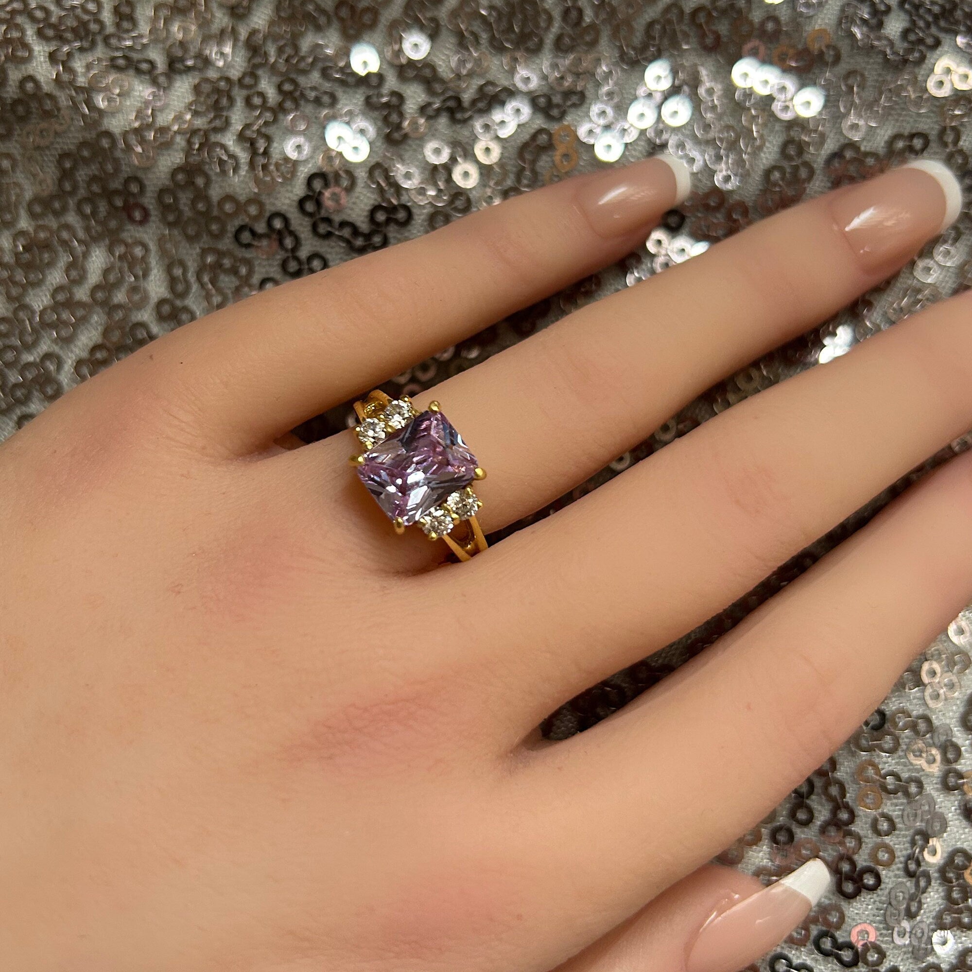 An absolute stunner, classic lavender amethyst engagement ring with an emerald cut gemstone of your choice as it’s centre stone and with round cut clear quartz on the band to further accentuate it.