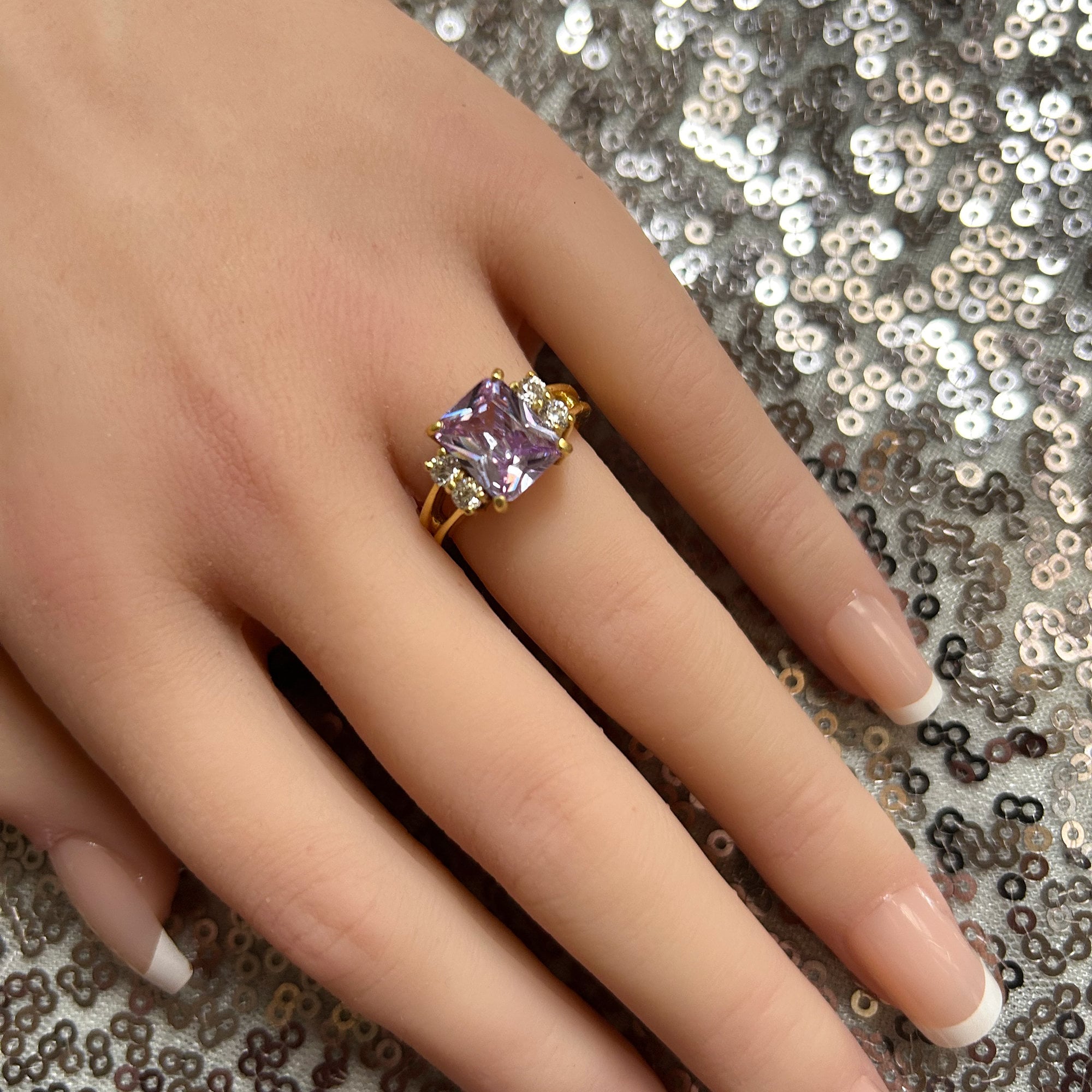 An absolute stunner, classic lavender amethyst engagement ring with an emerald cut gemstone of your choice as it’s centre stone and with round cut clear quartz on the band to further accentuate it.