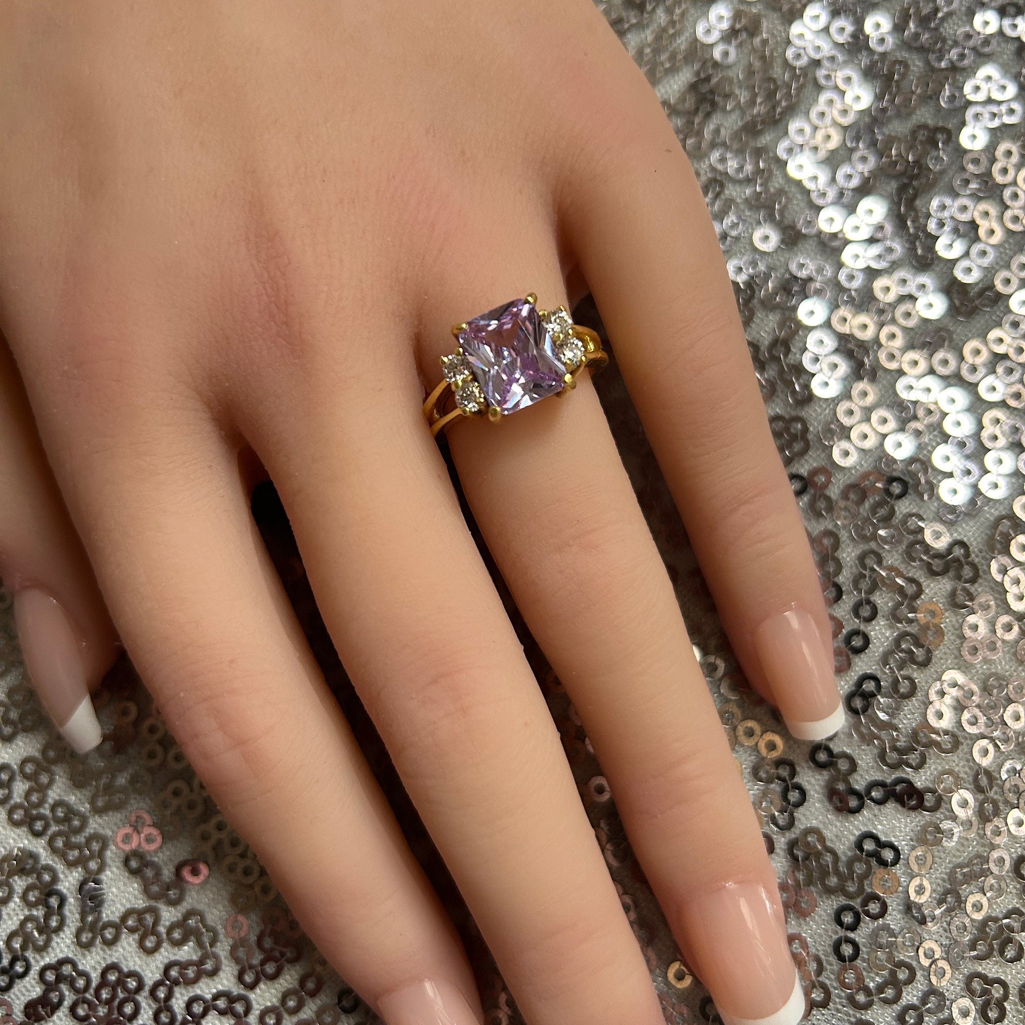 An absolute stunner, classic lavender amethyst engagement ring with an emerald cut gemstone of your choice as it’s centre stone and with round cut clear quartz on the band to further accentuate it.