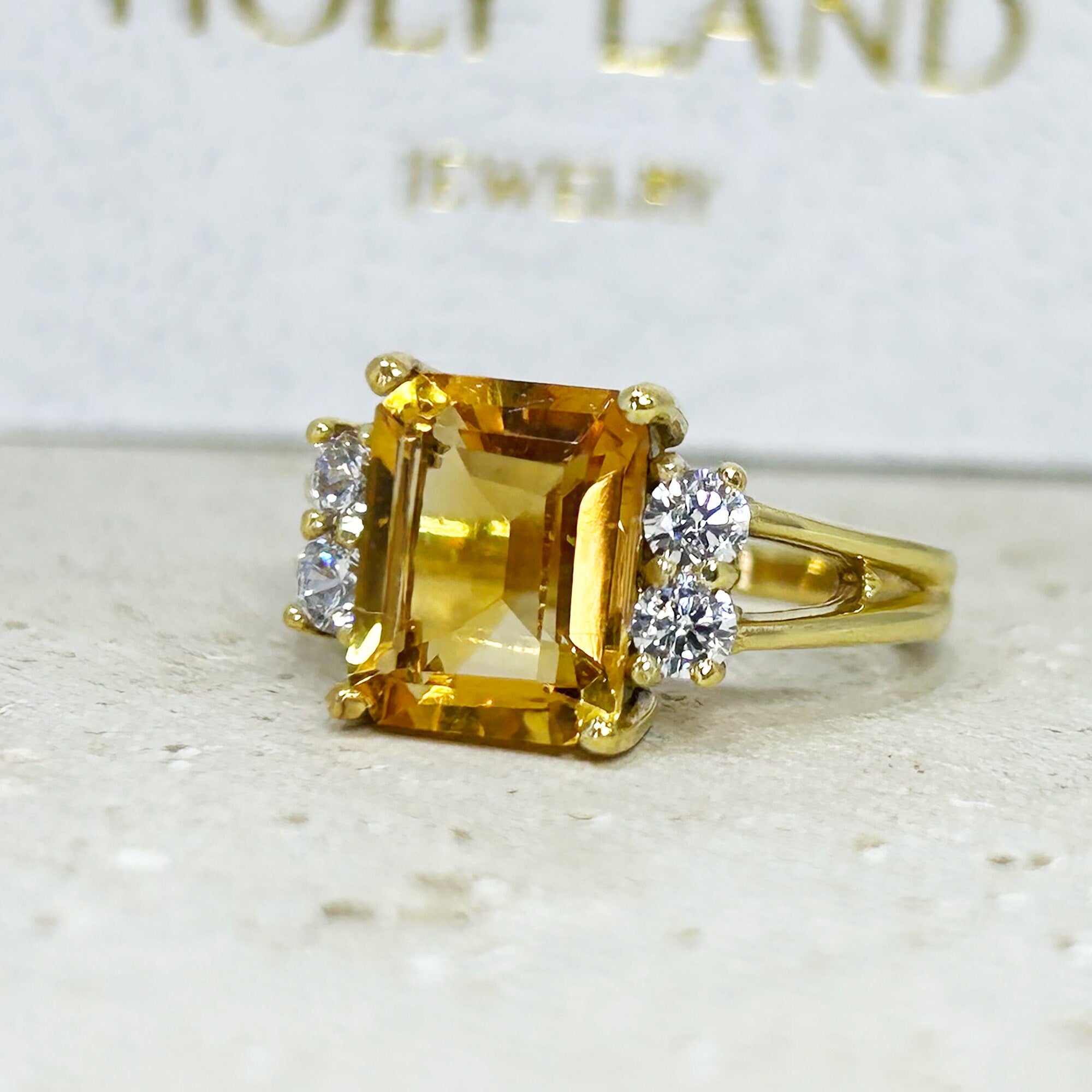 An absolute stunner, classic natural Citrine engagement ring with an emerald cut gemstone of your choice as it’s centre stone and with round cut clear quartz on the band to further accentuate it.