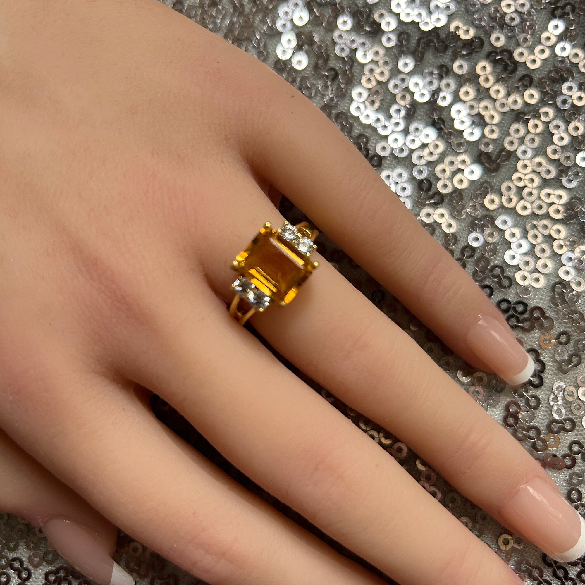 An absolute stunner, classic natural Citrine engagement ring with an emerald cut gemstone of your choice as it’s centre stone and with round cut clear quartz on the band to further accentuate it.