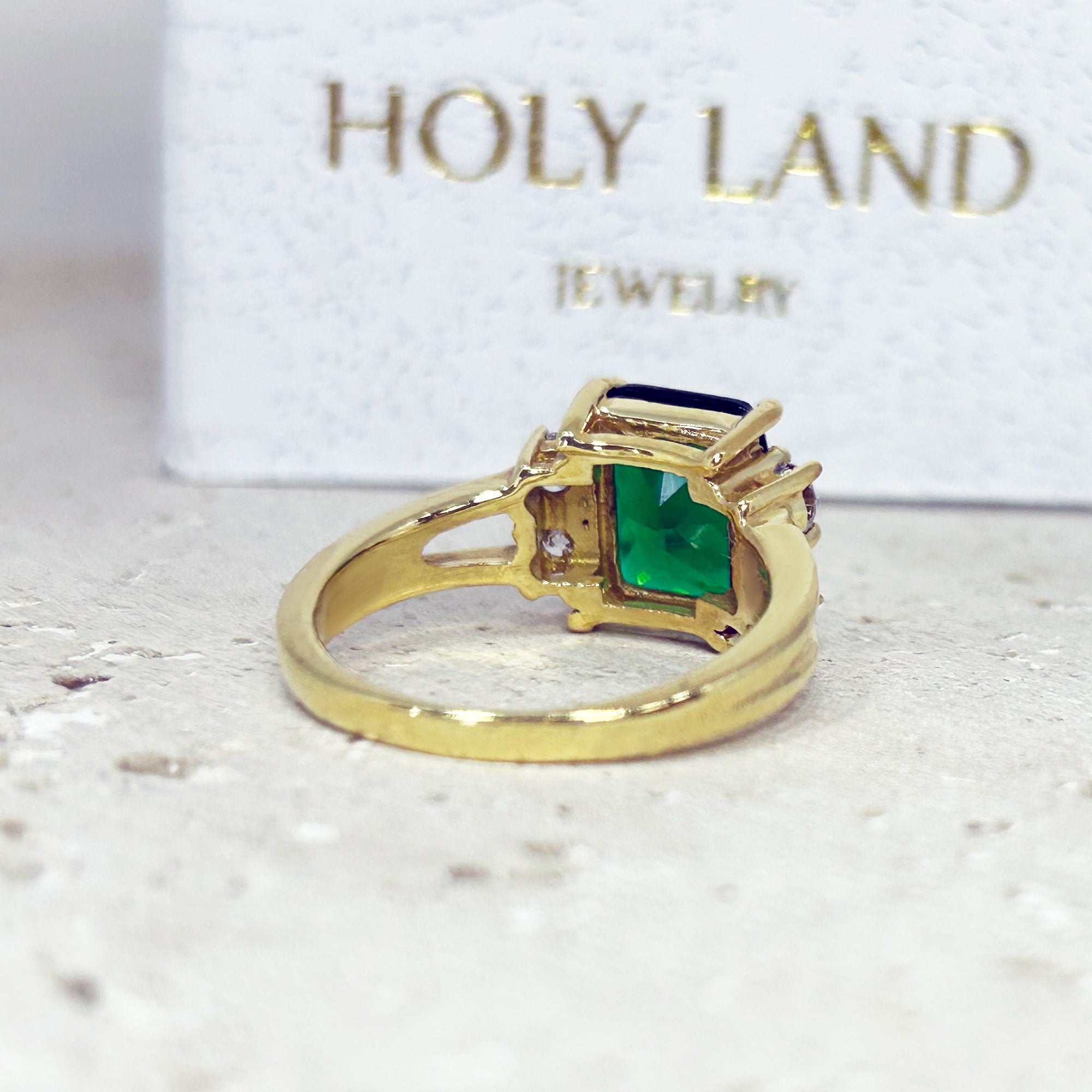 An absolute stunner, classic emerald engagement ring with an emerald cut gemstone of your choice as it’s centre stone and with round cut clear quartz on the band to further accentuate it.