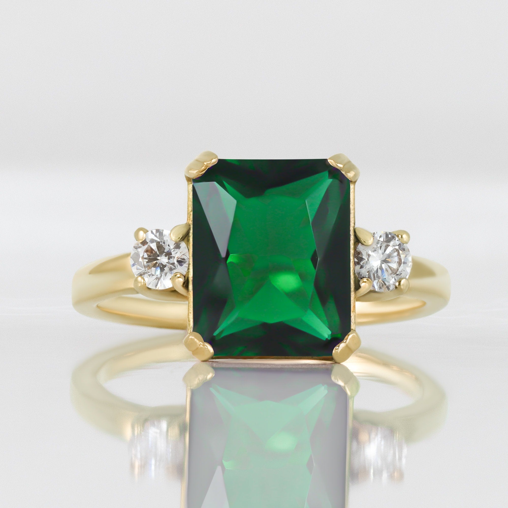 An absolute stunner, classic emerald engagement ring with an emerald cut gemstone of your choice as it’s centre stone and with round cut clear quartz on the band to further accentuate it.