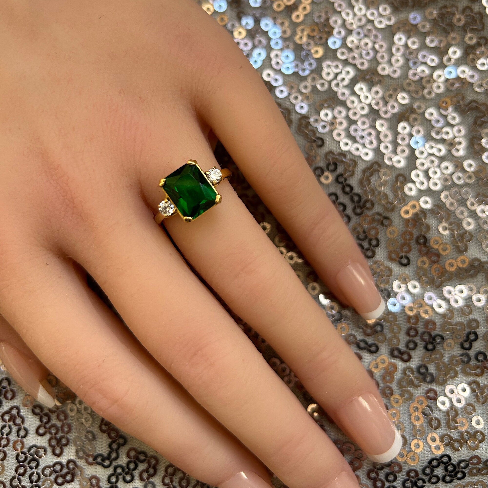 An absolute stunner, classic emerald engagement ring with an emerald cut gemstone of your choice as it’s centre stone and with round cut clear quartz on the band to further accentuate it.