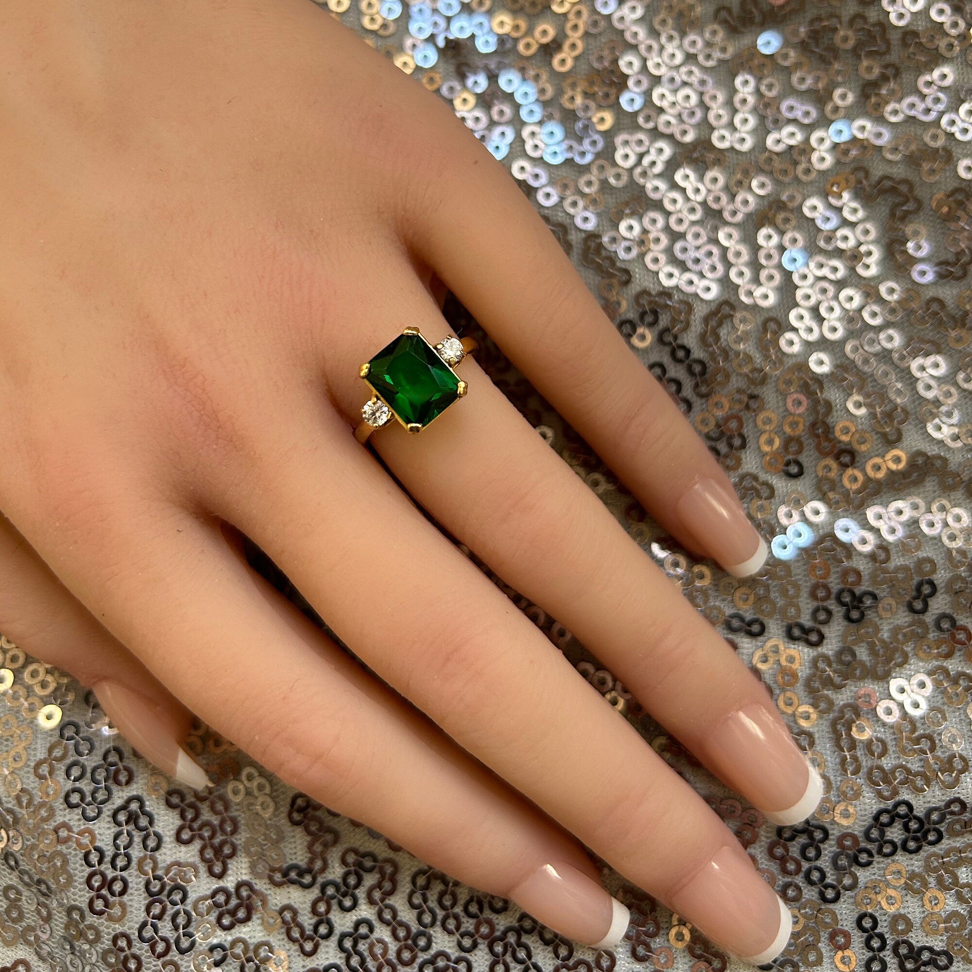 An absolute stunner, classic emerald engagement ring with an emerald cut gemstone of your choice as it’s centre stone and with round cut clear quartz on the band to further accentuate it.