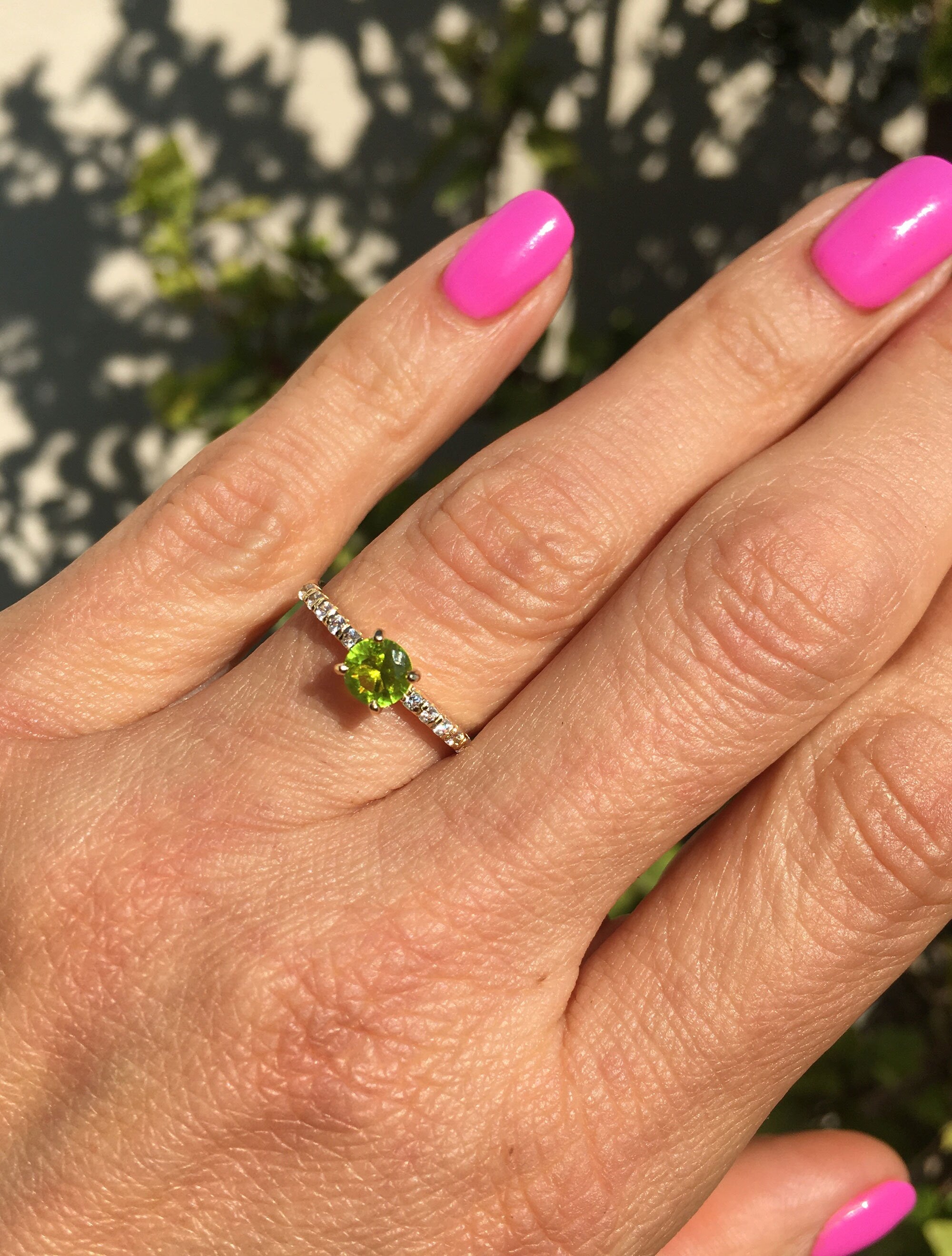 An absolute stunner, classic peridot engagement ring with a round cut gemstone of your choice as it’s centre stone and with round cut clear quartz on the band to further accentuate it.