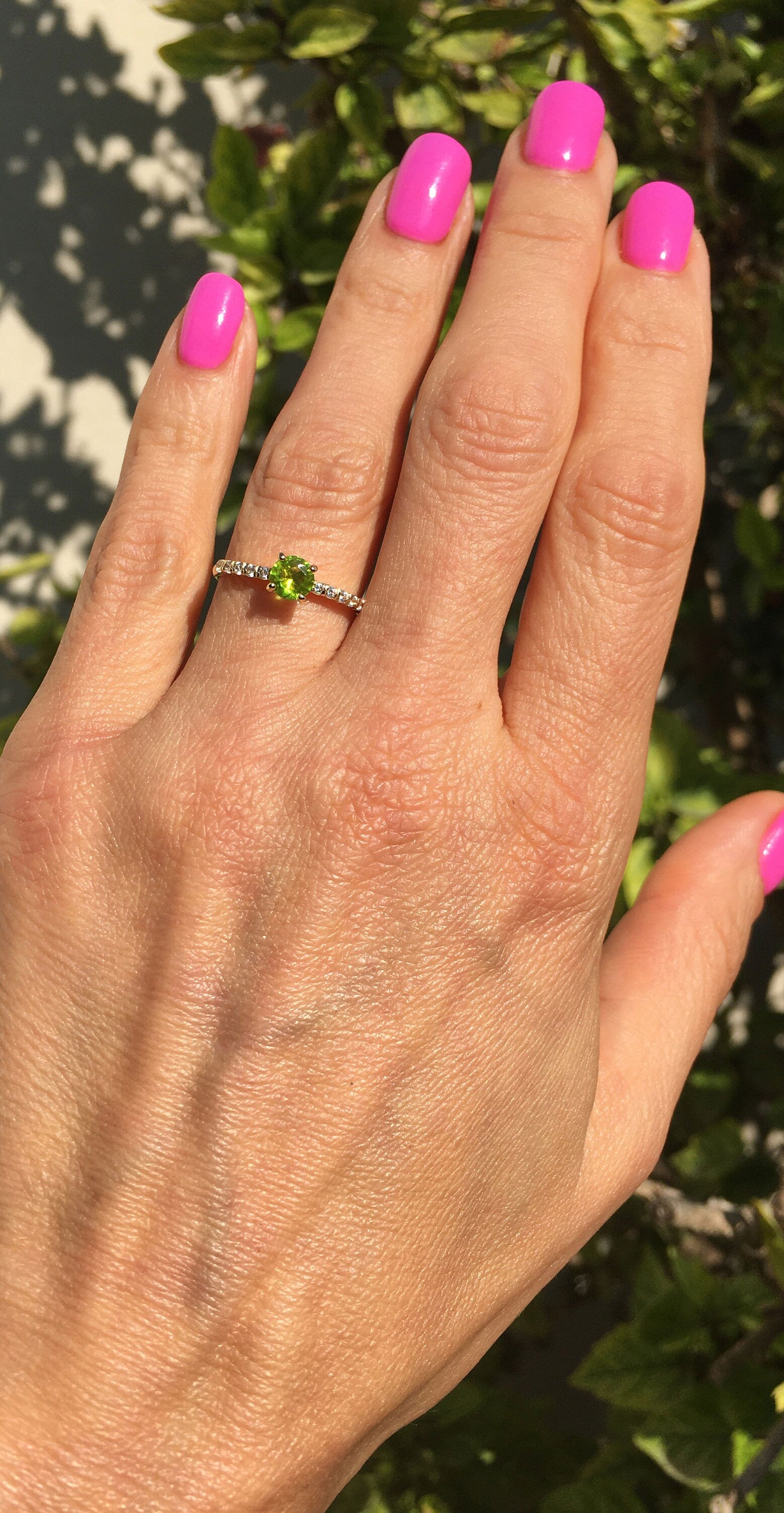 An absolute stunner, classic peridot engagement ring with a round cut gemstone of your choice as it’s centre stone and with round cut clear quartz on the band to further accentuate it.