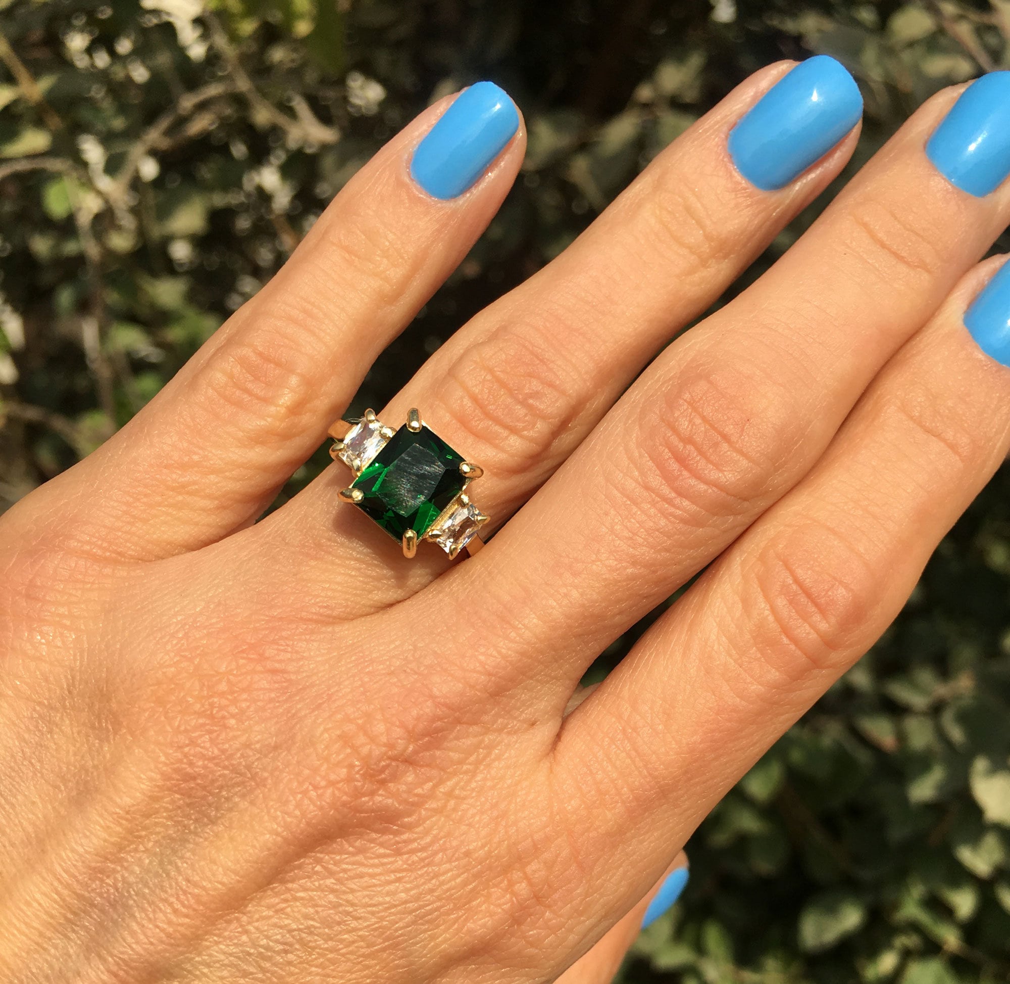 An absolute stunner, classic emerald engagement ring with an emerald cut gemstone of your choice as it’s centre stone and with clear quartz on the band to further accentuate it.