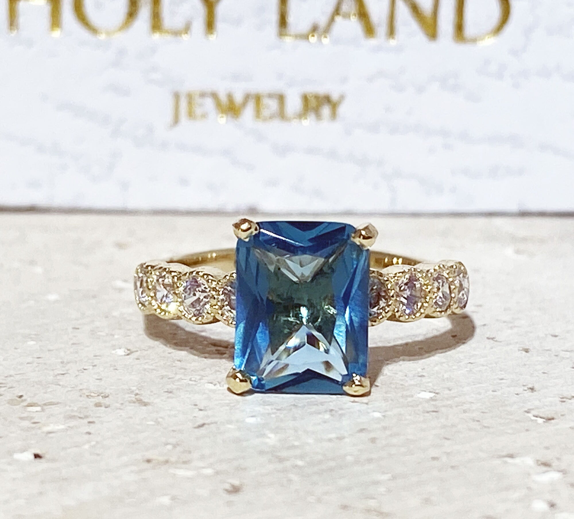 An absolute stunner, classic blue topaz engagement ring with a pear cut gemstone of your choice as it’s centre stone and with round cut clear quartz on the band to further accentuate it.