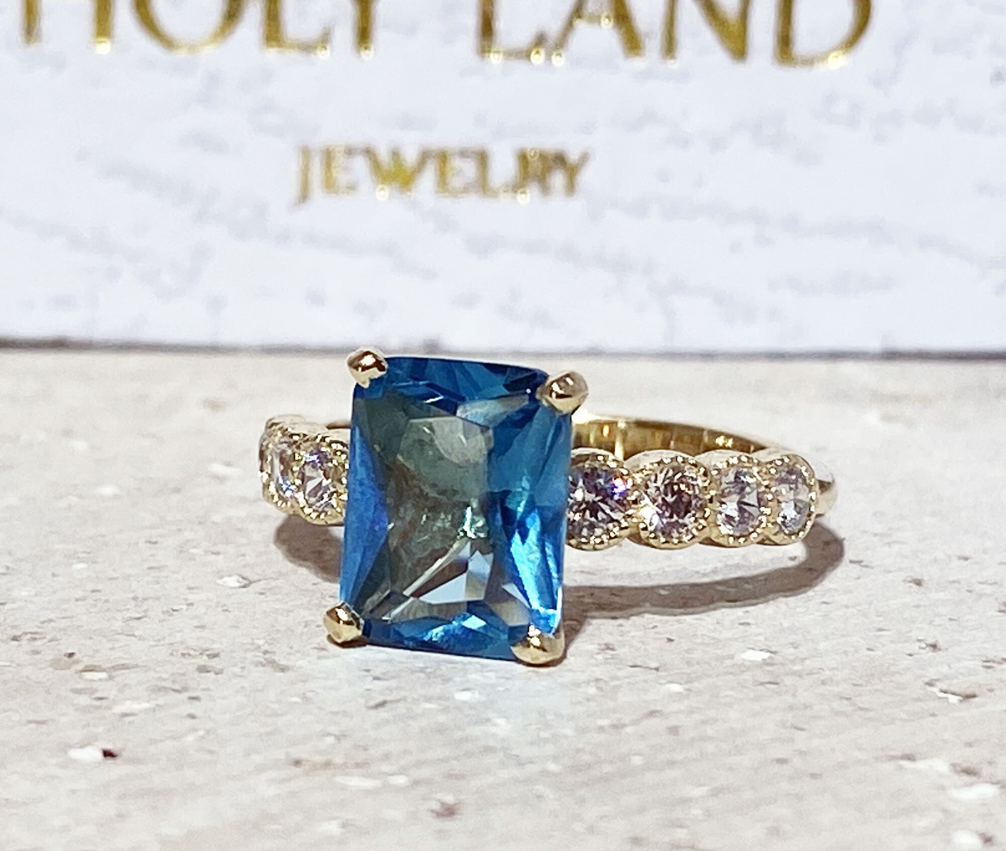 An absolute stunner, classic blue topaz engagement ring with a pear cut gemstone of your choice as it’s centre stone and with round cut clear quartz on the band to further accentuate it.