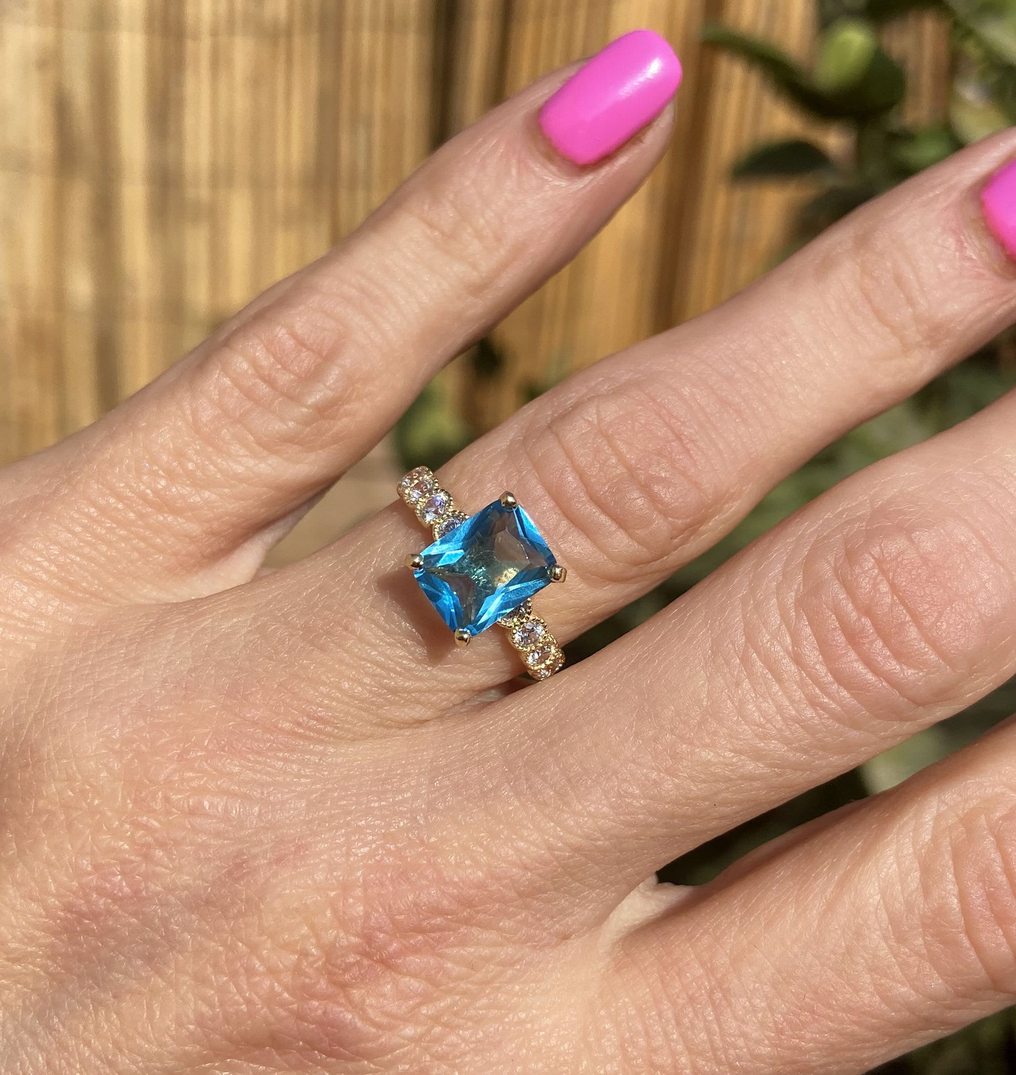 An absolute stunner, classic blue topaz engagement ring with a pear cut gemstone of your choice as it’s centre stone and with round cut clear quartz on the band to further accentuate it.