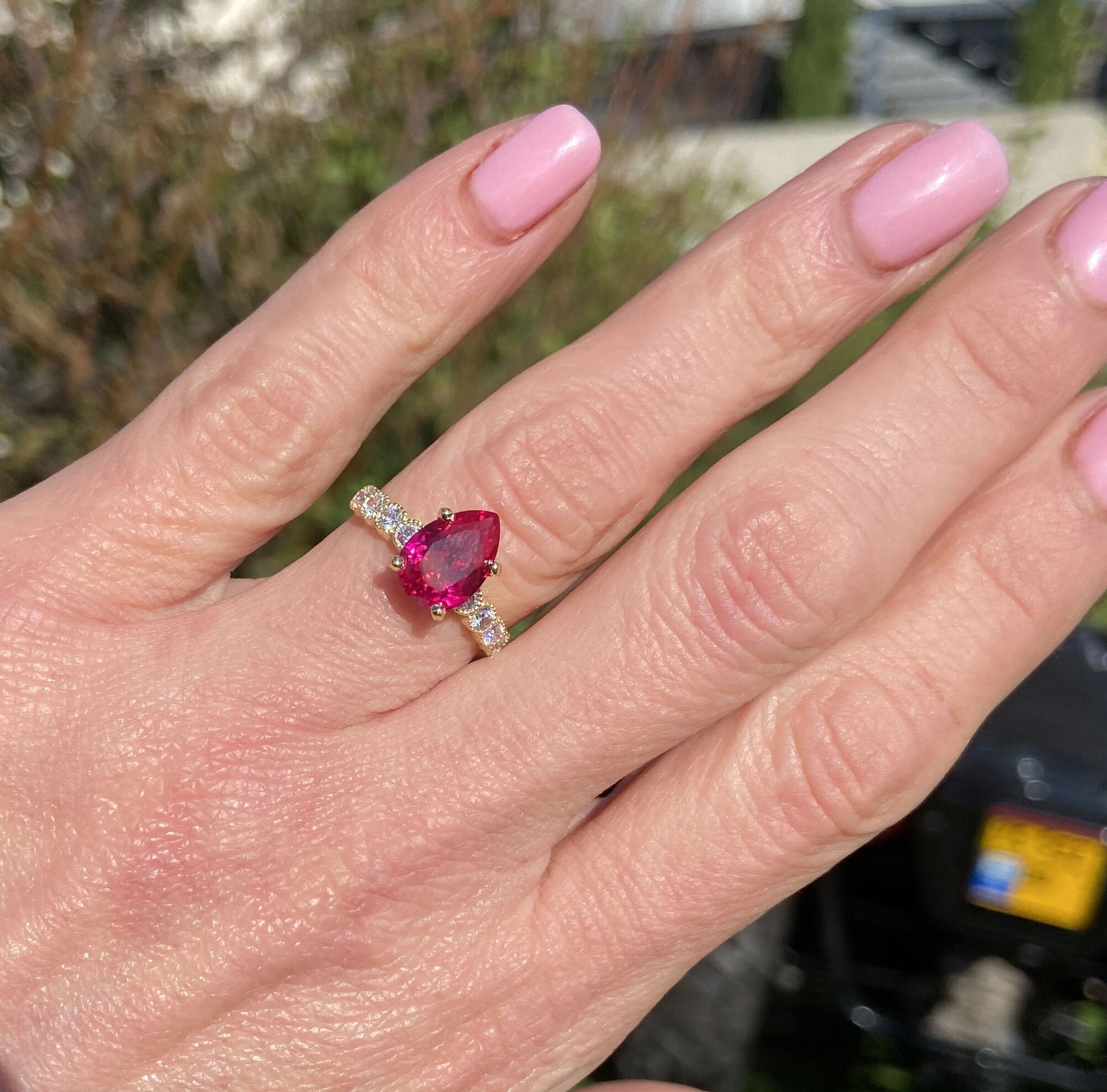 An absolute stunner, classic ruby engagement ring with a pear cut gemstone of your choice as it’s centre stone and with round cut clear quartz on the band to further accentuate it.