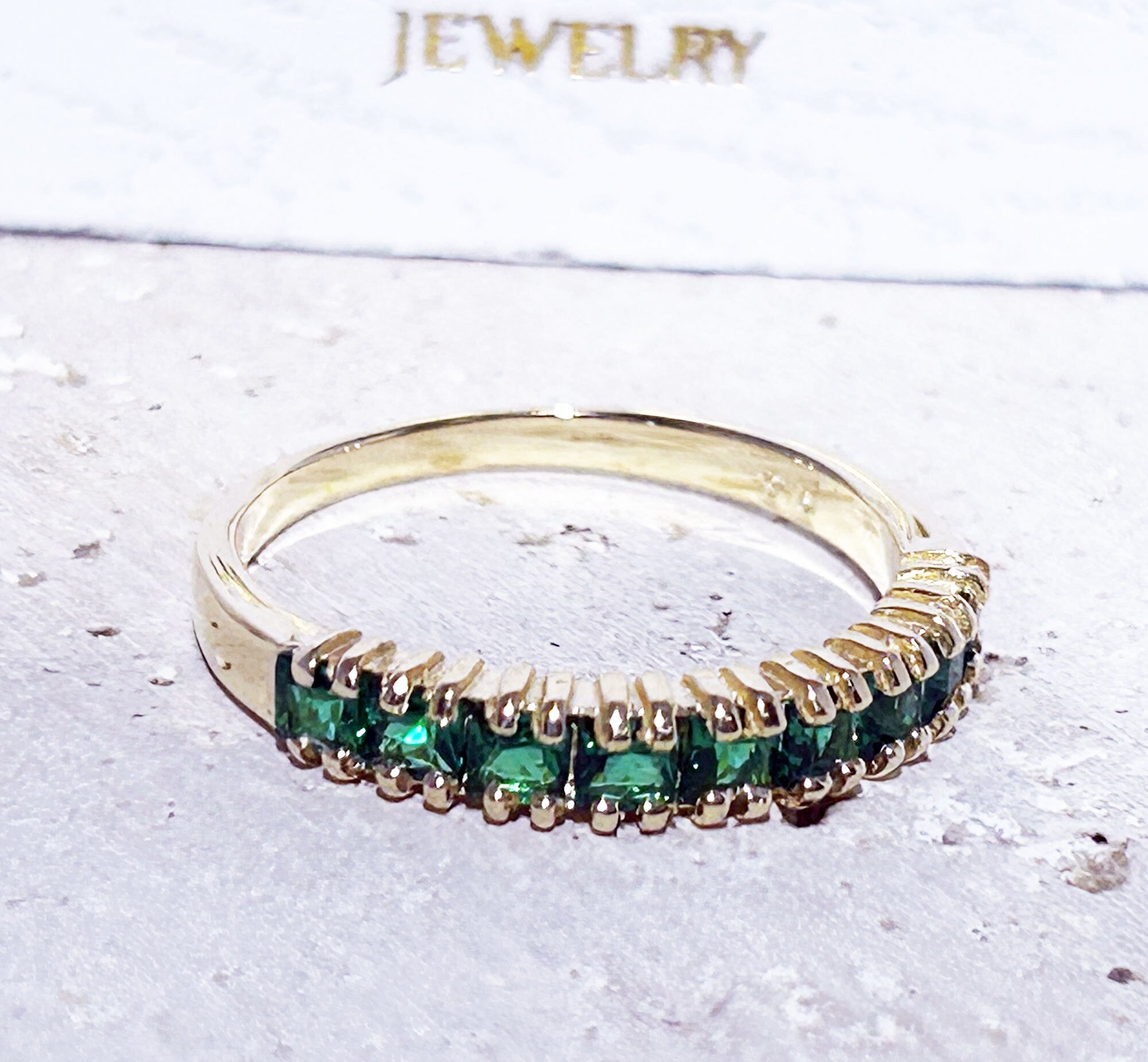 This stylish emerald half eternity ring is beautifully displayed, the fine craftsmanship shows off the row of emeralds, and their stunning sparkle. It&#39;s a beautiful gift ring for anybody who loves gemstones.