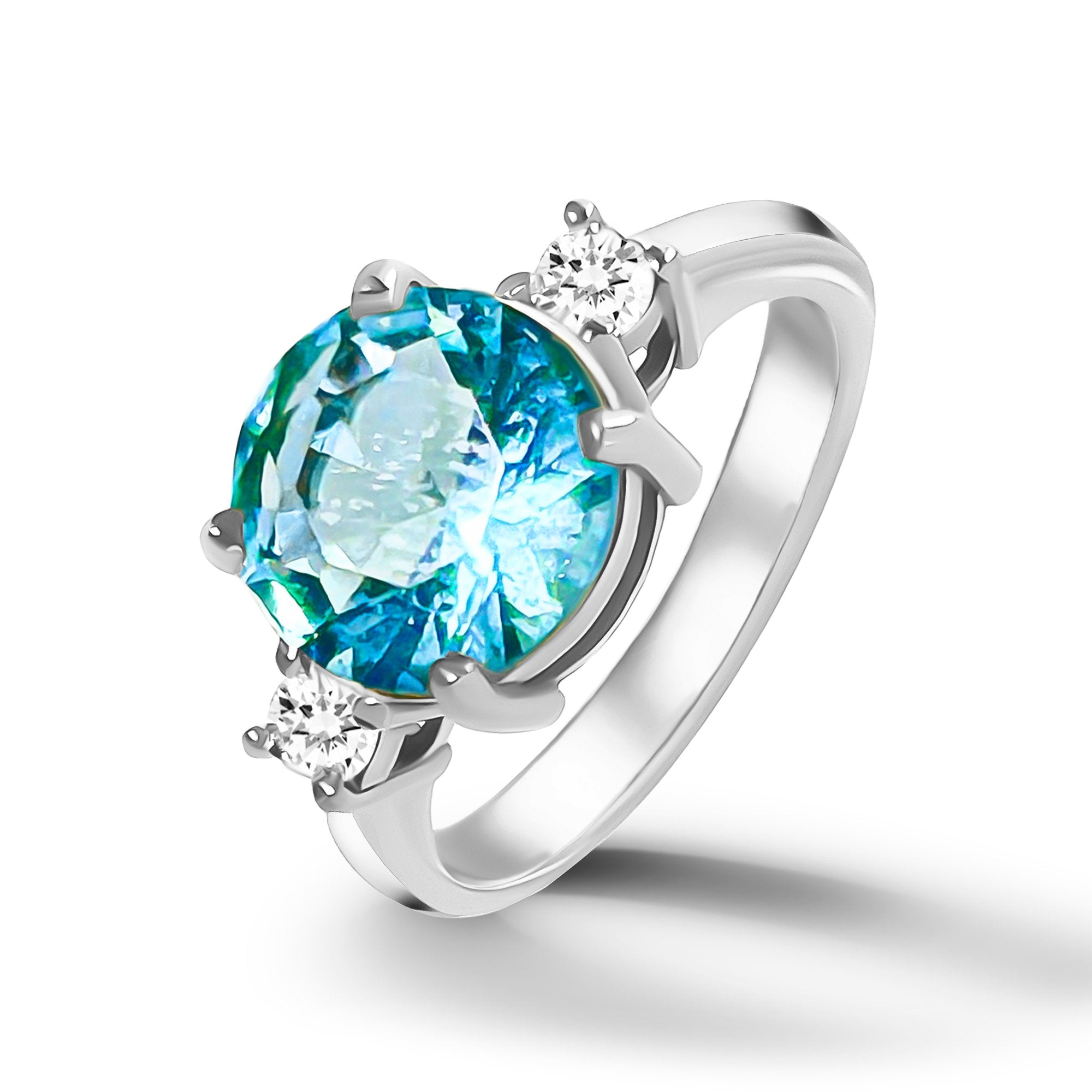 This gorgeous and elegant women&#39;s ring features a round-cut blue topaz gemstone with two round-cut dazzling clear quartz. This beautiful ring is enhanced with a high polish finish.