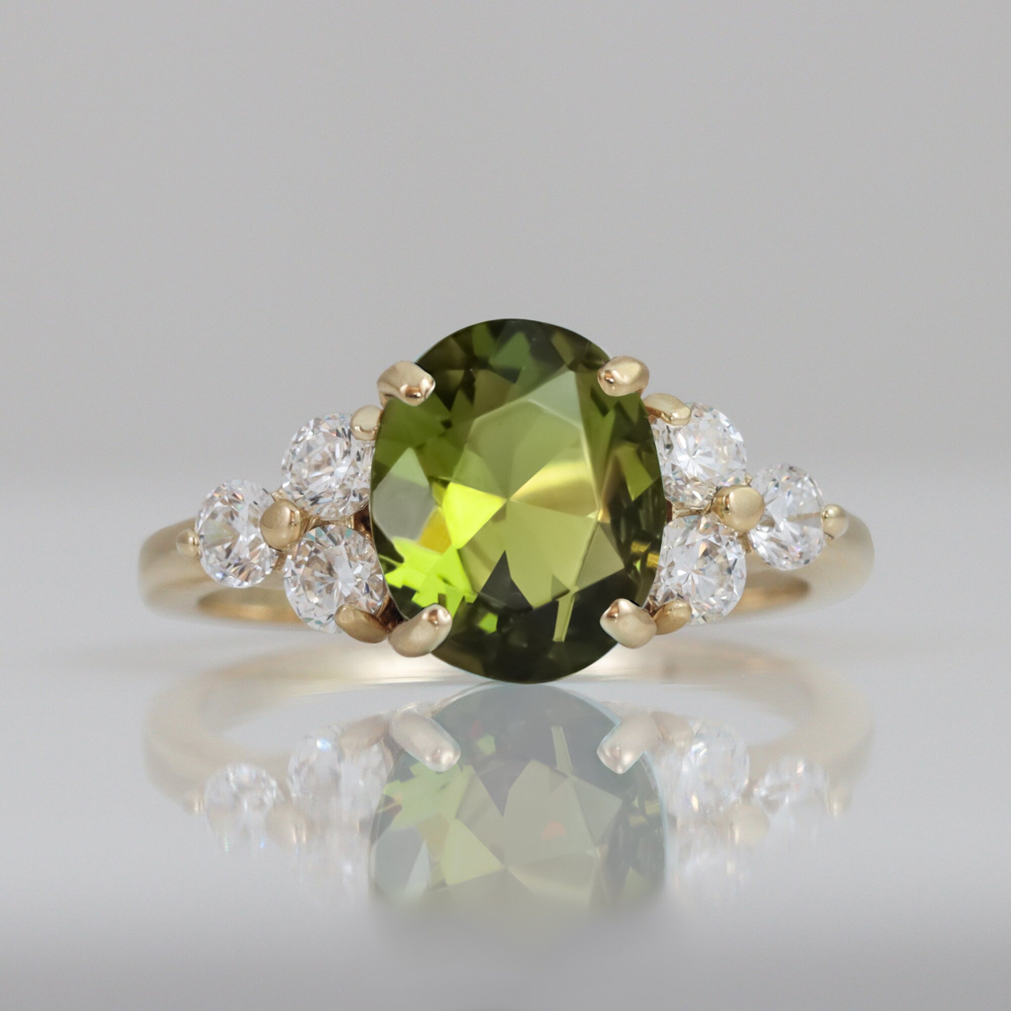 Radiant Elegance: Statement Engagement Ring with Oval Peridot Gemstone and Clear Quartz Accents