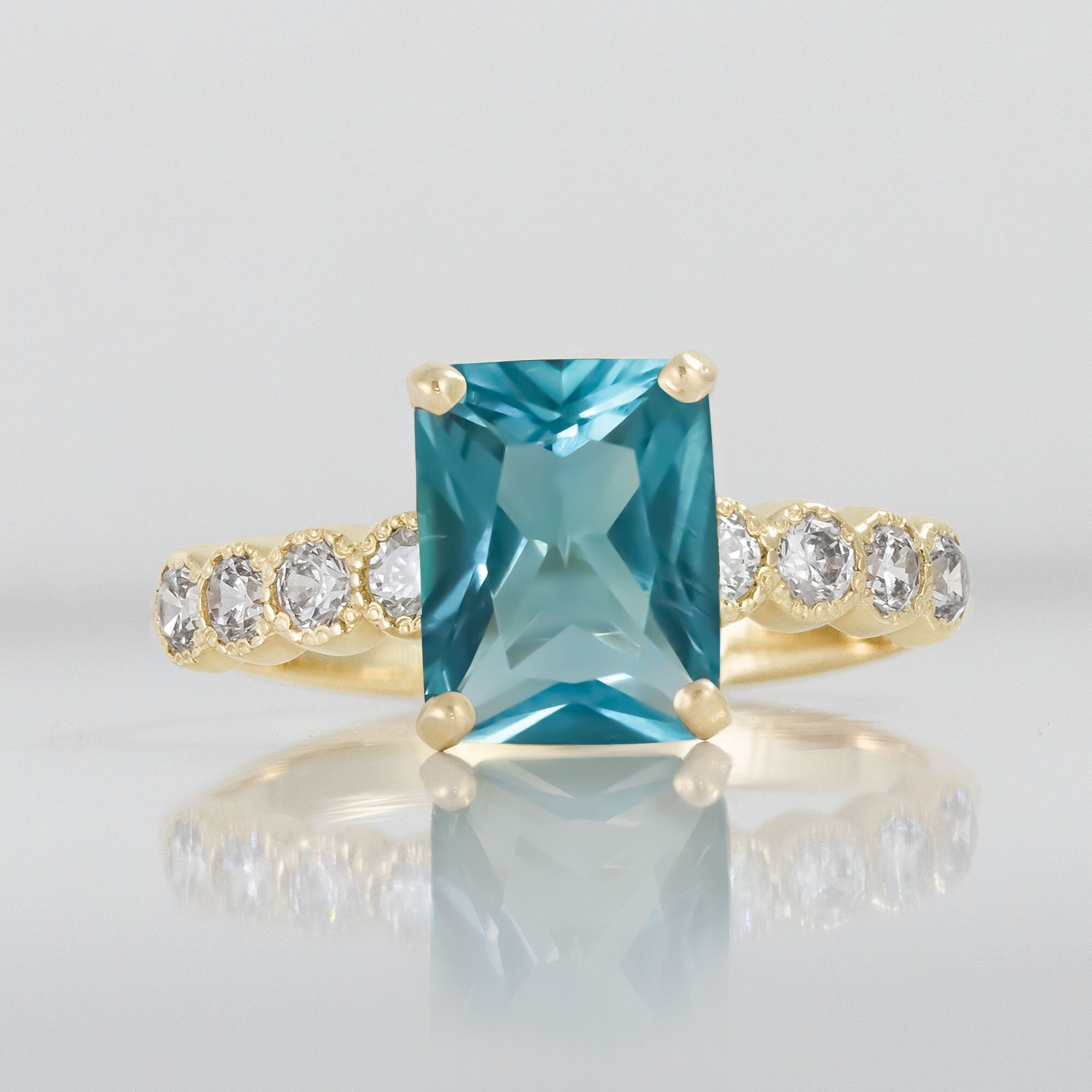 An absolute stunner, classic blue topaz engagement ring with a pear cut gemstone of your choice as it’s centre stone and with round cut clear quartz on the band to further accentuate it.