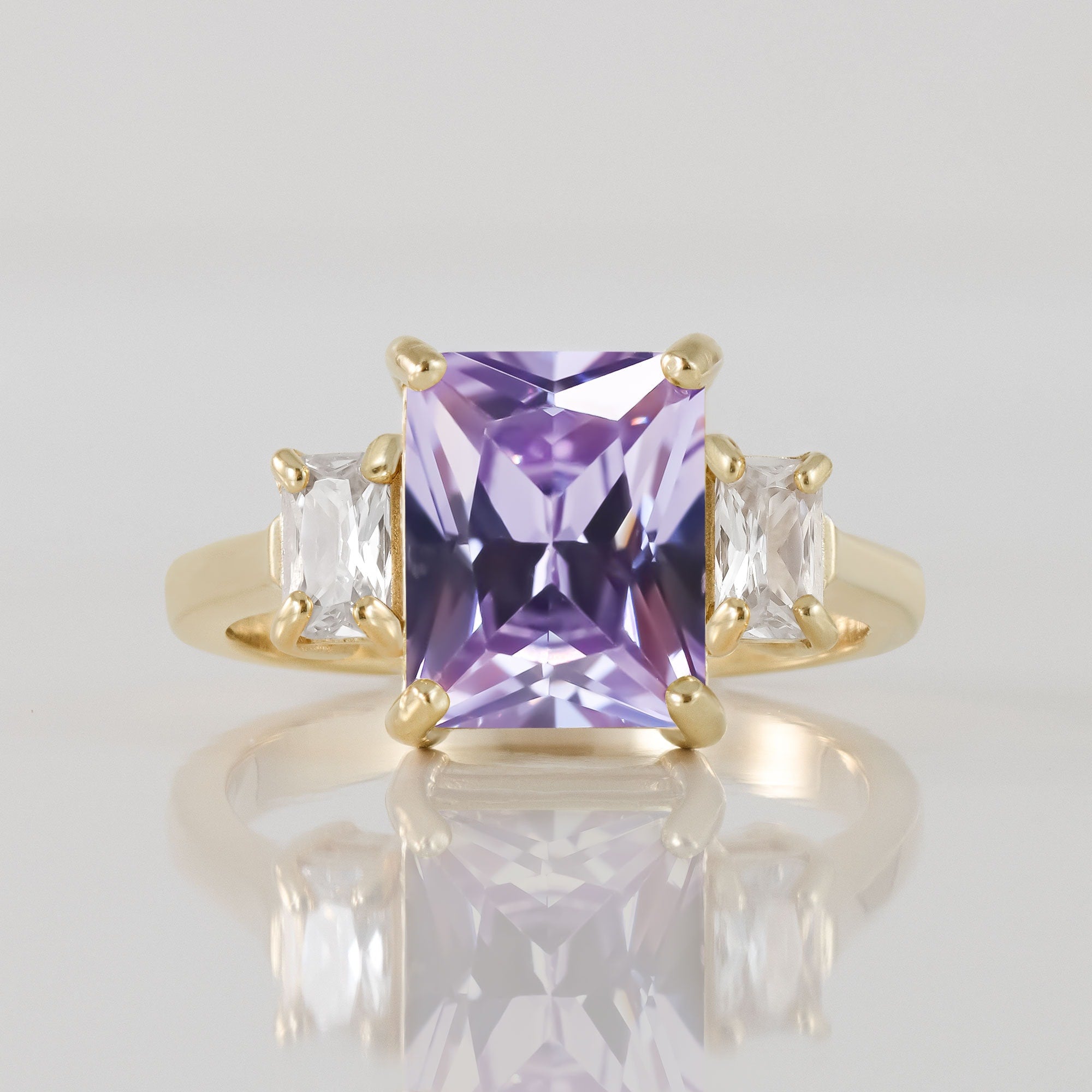 An absolute stunner, classic lavender amethyst engagement ring with an emerald cut gemstone of your choice as it’s centre stone and with clear quartz on the band to further accentuate it.