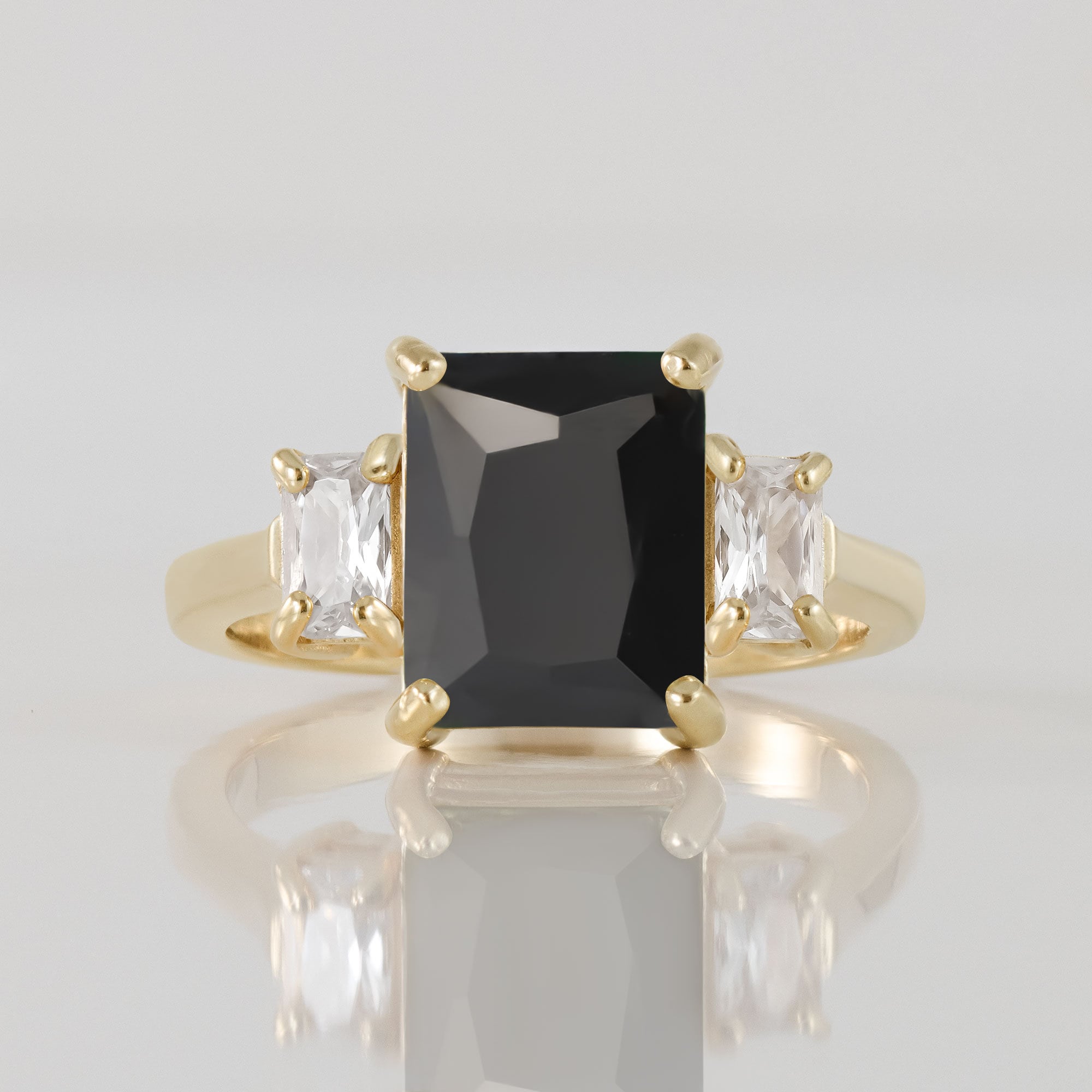 An absolute stunner, classic natural black onyx engagement ring with an emerald cut gemstone of your choice as it’s centre stone and with clear quartz on the band to further accentuate it.