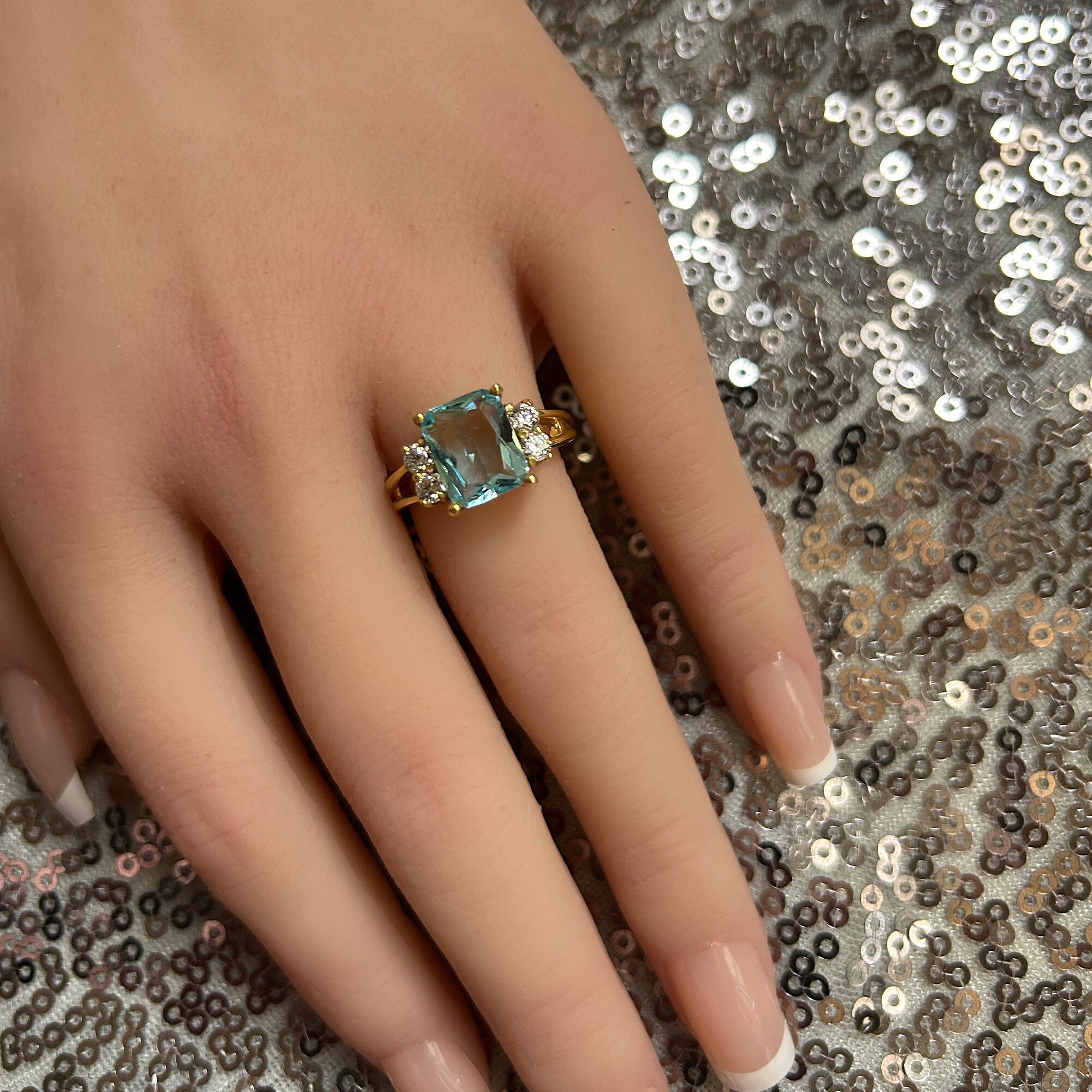 An absolute stunner, classic aquamarine engagement ring with an emerald cut gemstone of your choice as it’s centre stone and with round cut clear quartz on the band to further accentuate it.