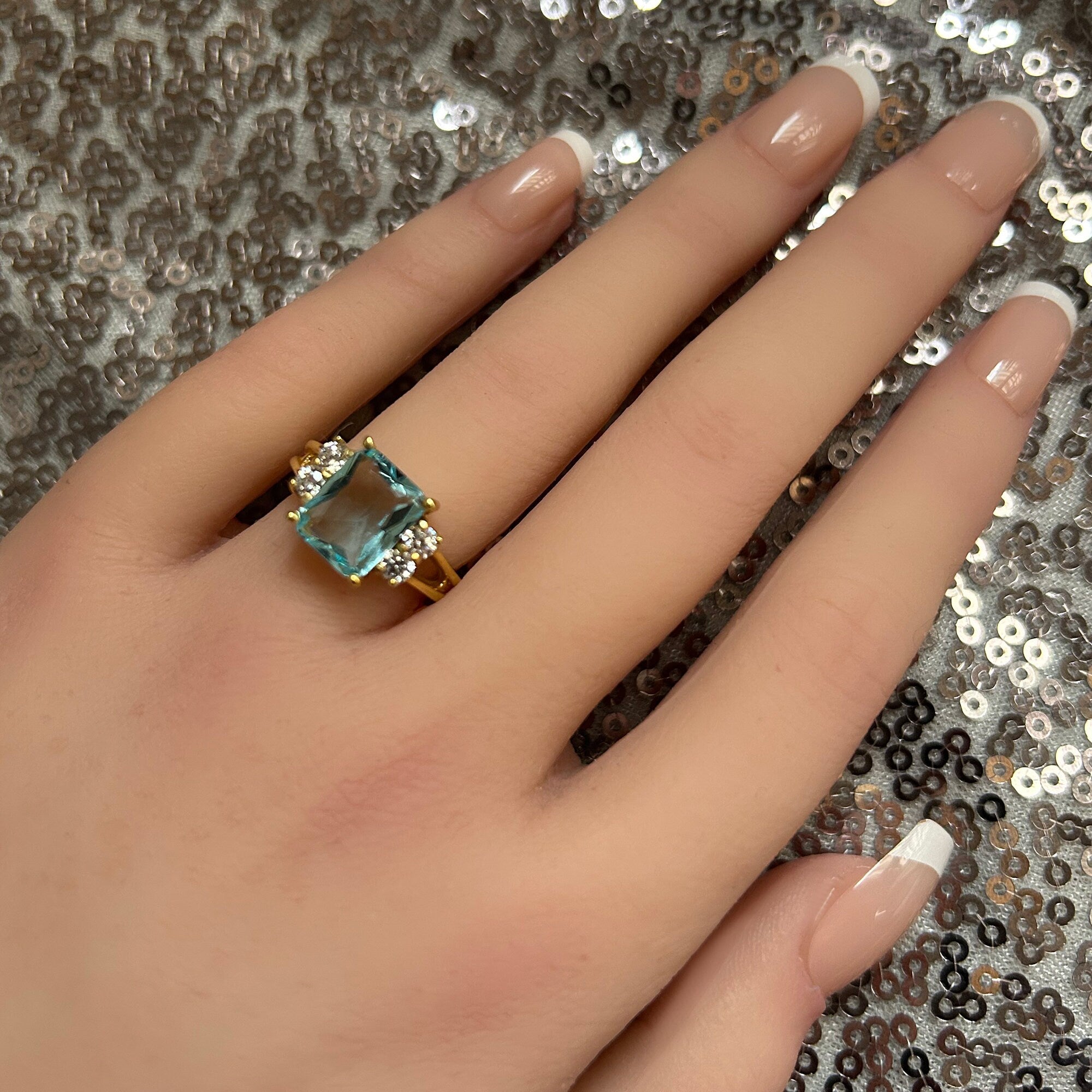 An absolute stunner, classic aquamarine engagement ring with an emerald cut gemstone of your choice as it’s centre stone and with round cut clear quartz on the band to further accentuate it.