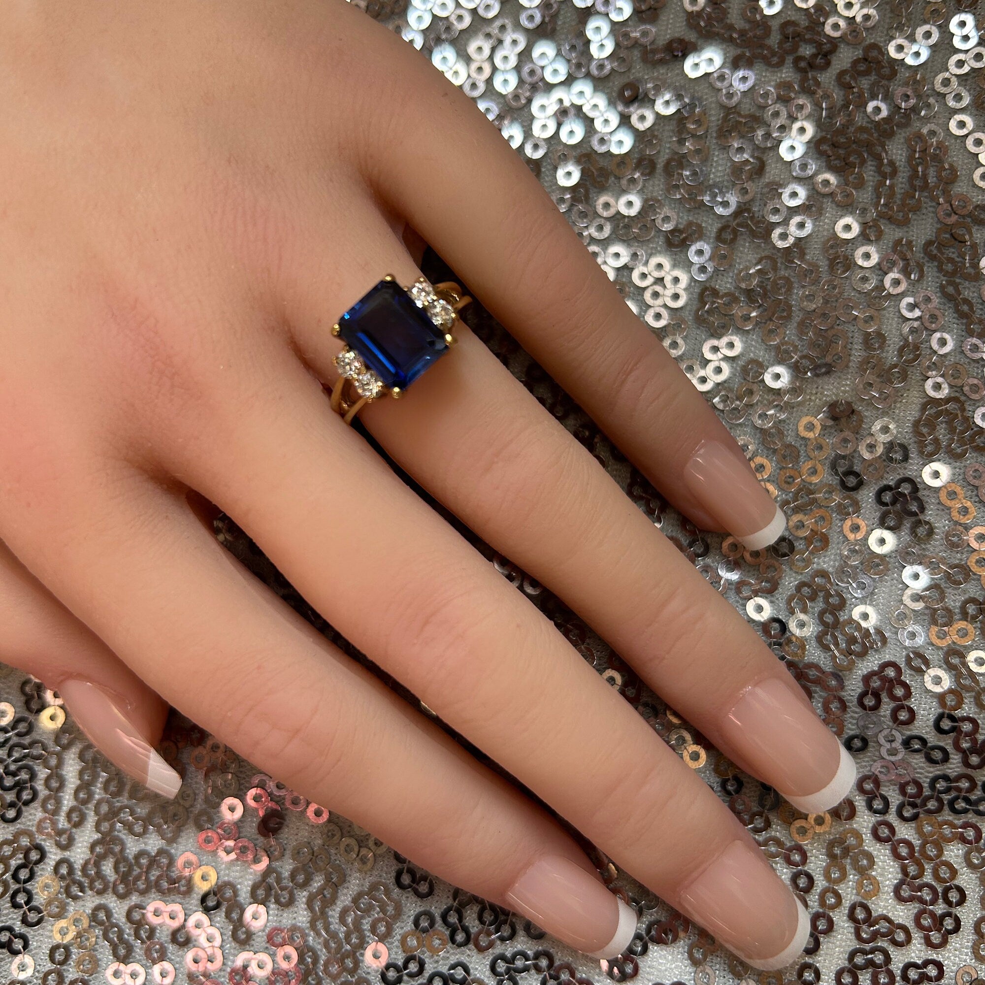 An absolute stunner, classic blue sapphire engagement ring with an emerald cut gemstone of your choice as it’s centre stone and with round cut clear quartz on the band to further accentuate it.