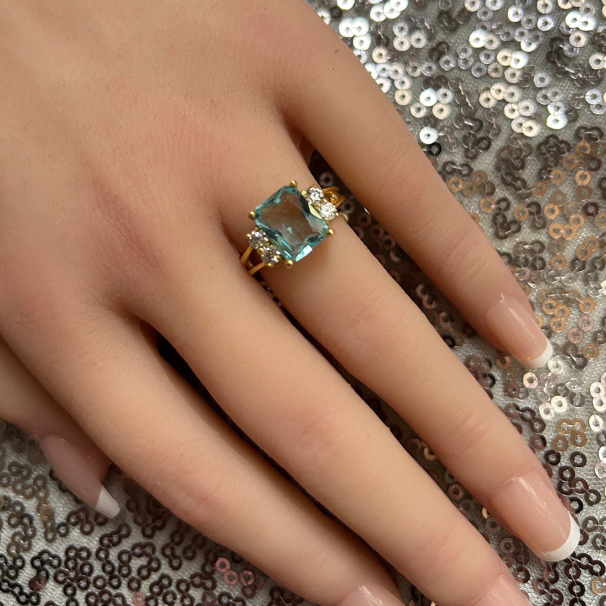 An absolute stunner, classic aquamarine engagement ring with an emerald cut gemstone of your choice as it’s centre stone and with round cut clear quartz on the band to further accentuate it.