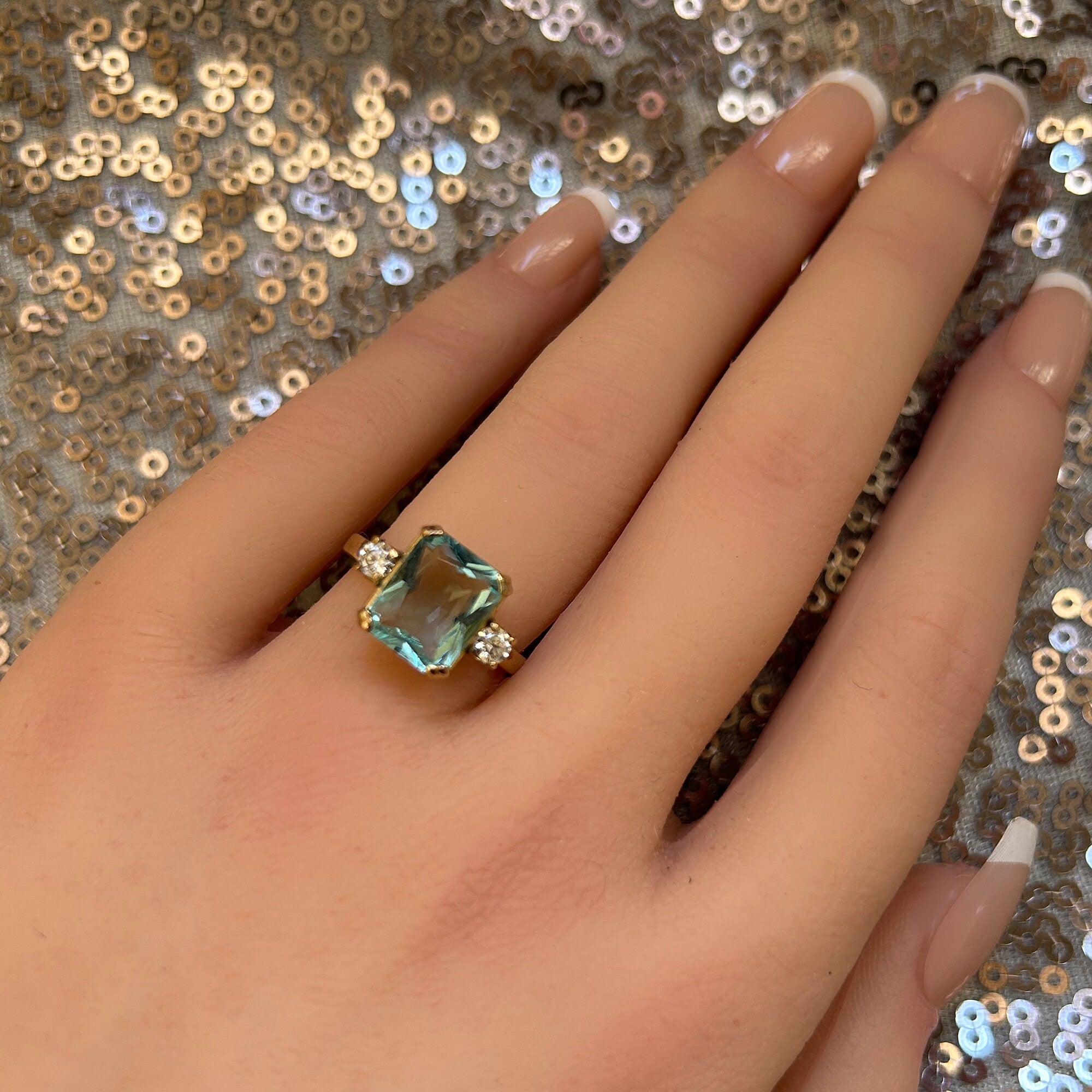 An absolute stunner, classic aquamarine engagement ring with an emerald cut gemstone of your choice as it’s centre stone and with round cut clear quartz on the band to further accentuate it.