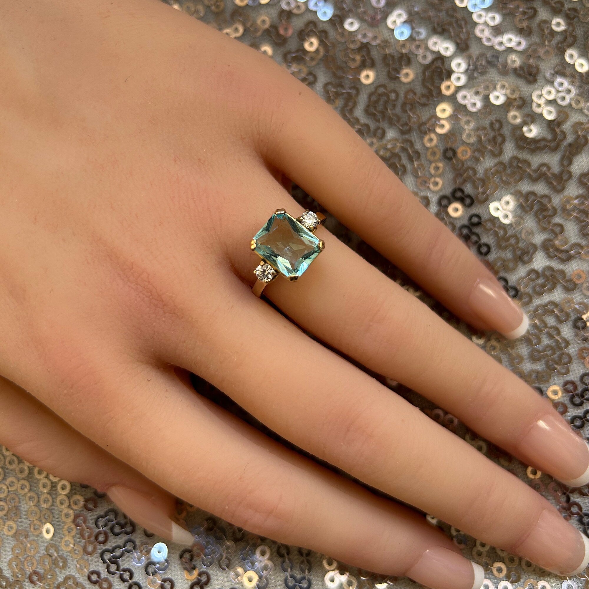 An absolute stunner, classic aquamarine engagement ring with an emerald cut gemstone of your choice as it’s centre stone and with round cut clear quartz on the band to further accentuate it.