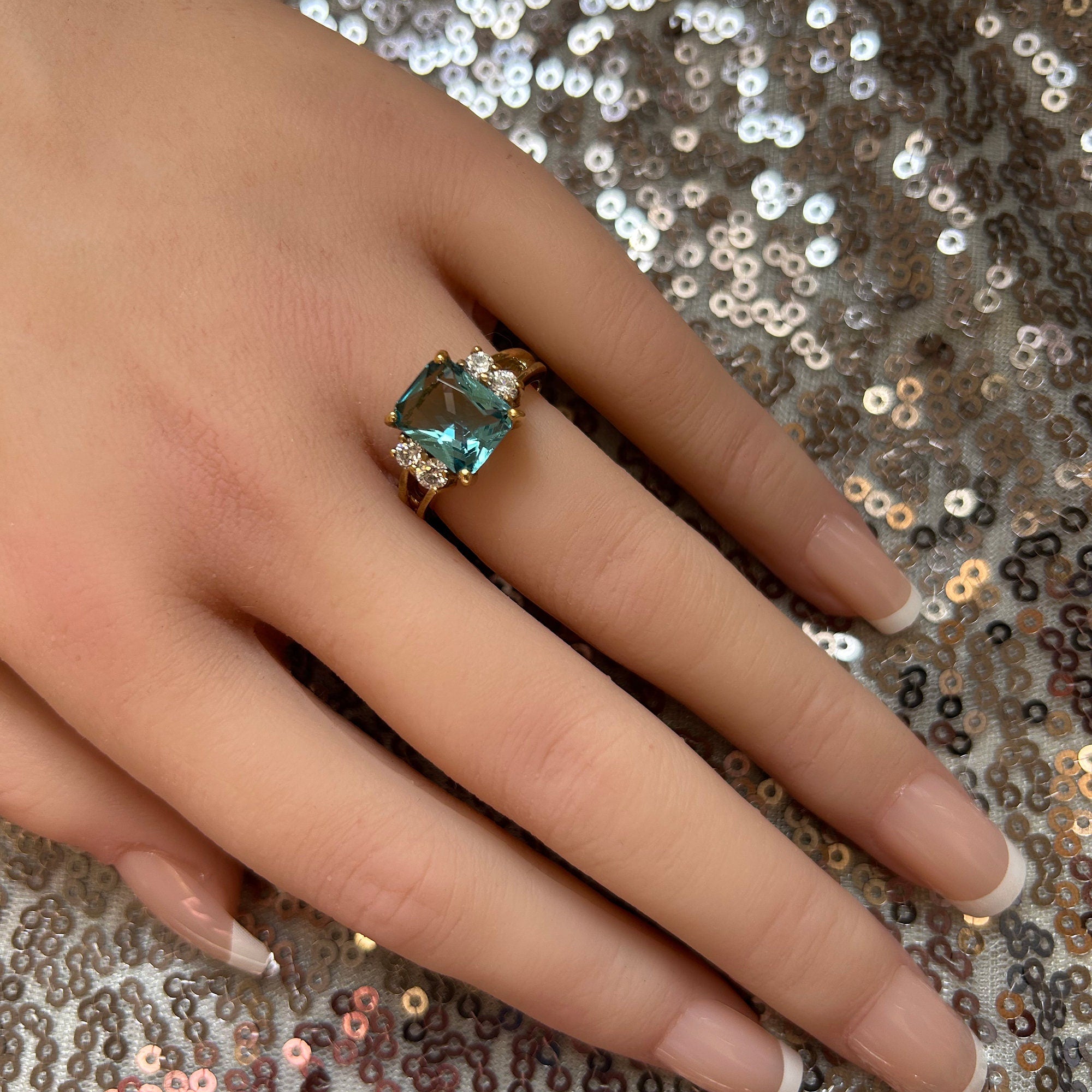 An absolute stunner, classic blue topaz engagement ring with an emerald cut gemstone of your choice as it’s centre stone and with round cut clear quartz on the band to further accentuate it.