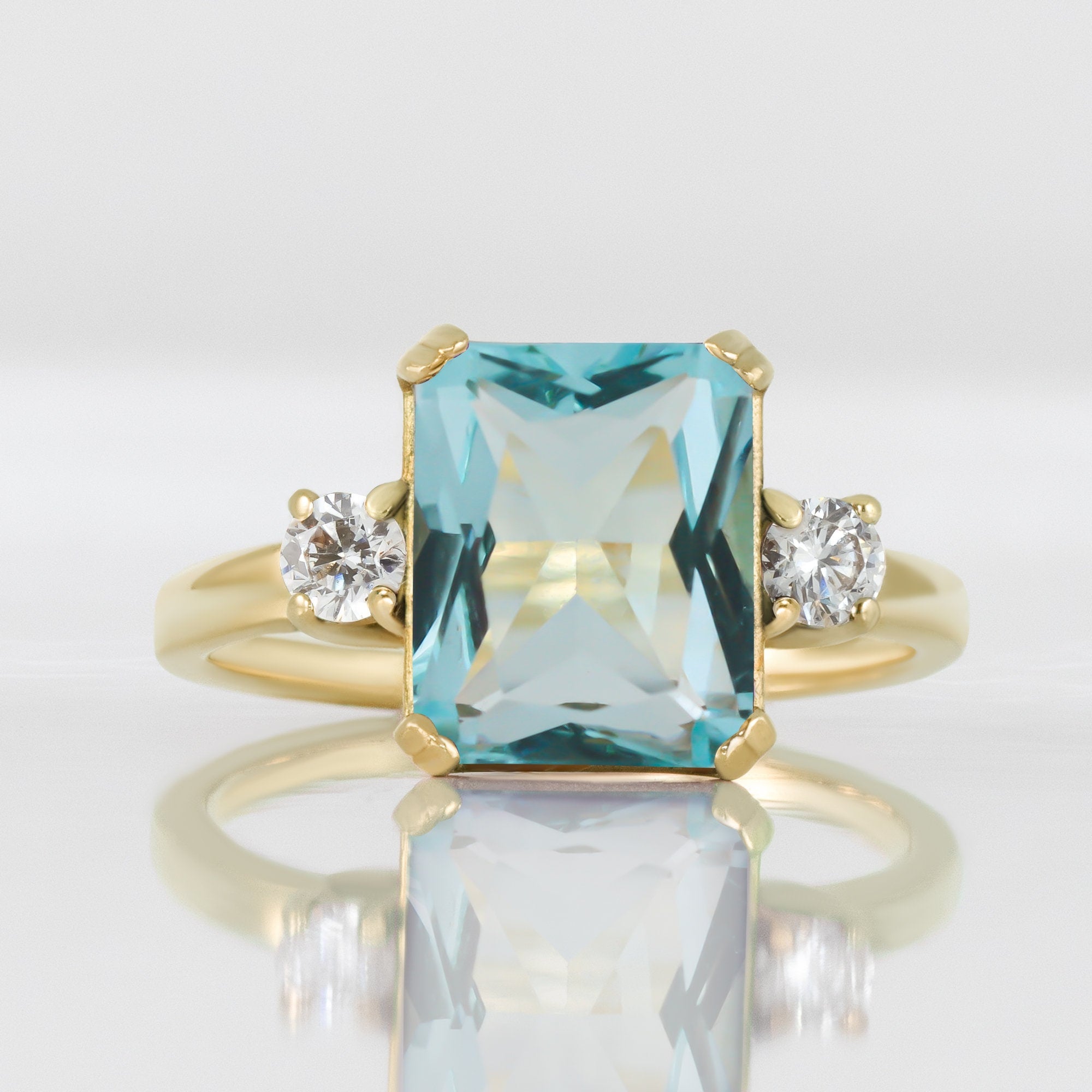 An absolute stunner, classic aquamarine engagement ring with an emerald cut gemstone of your choice as it’s centre stone and with round cut clear quartz on the band to further accentuate it.